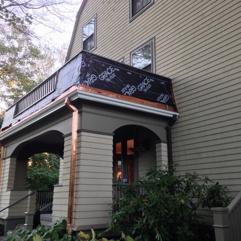 A house with a porch and a copper gutter