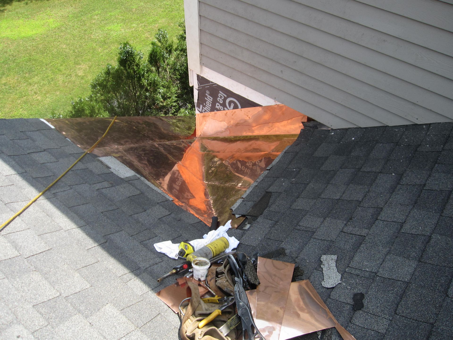 The roof of a house is being repaired with tools