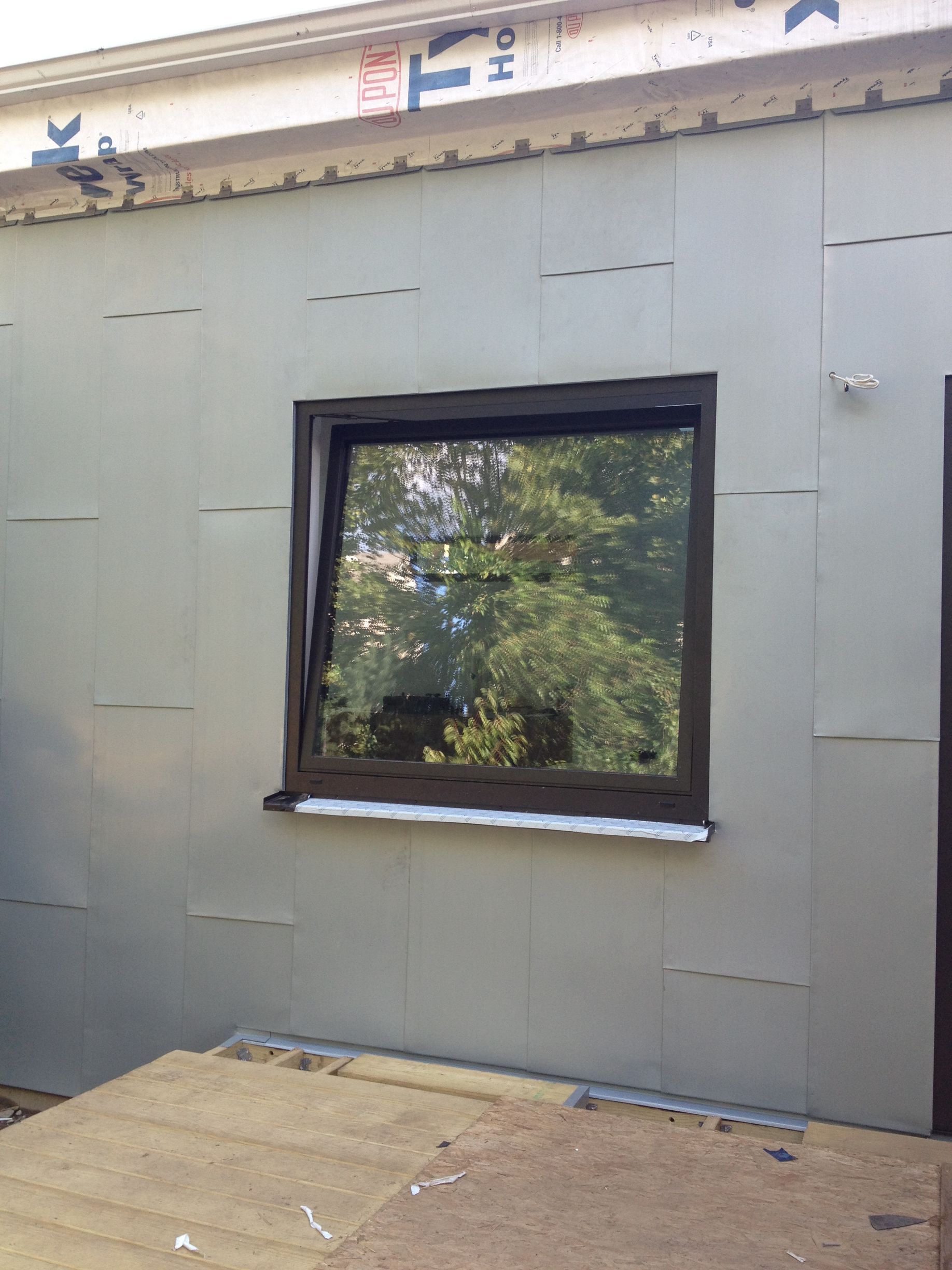 A window on the side of a building that is being built