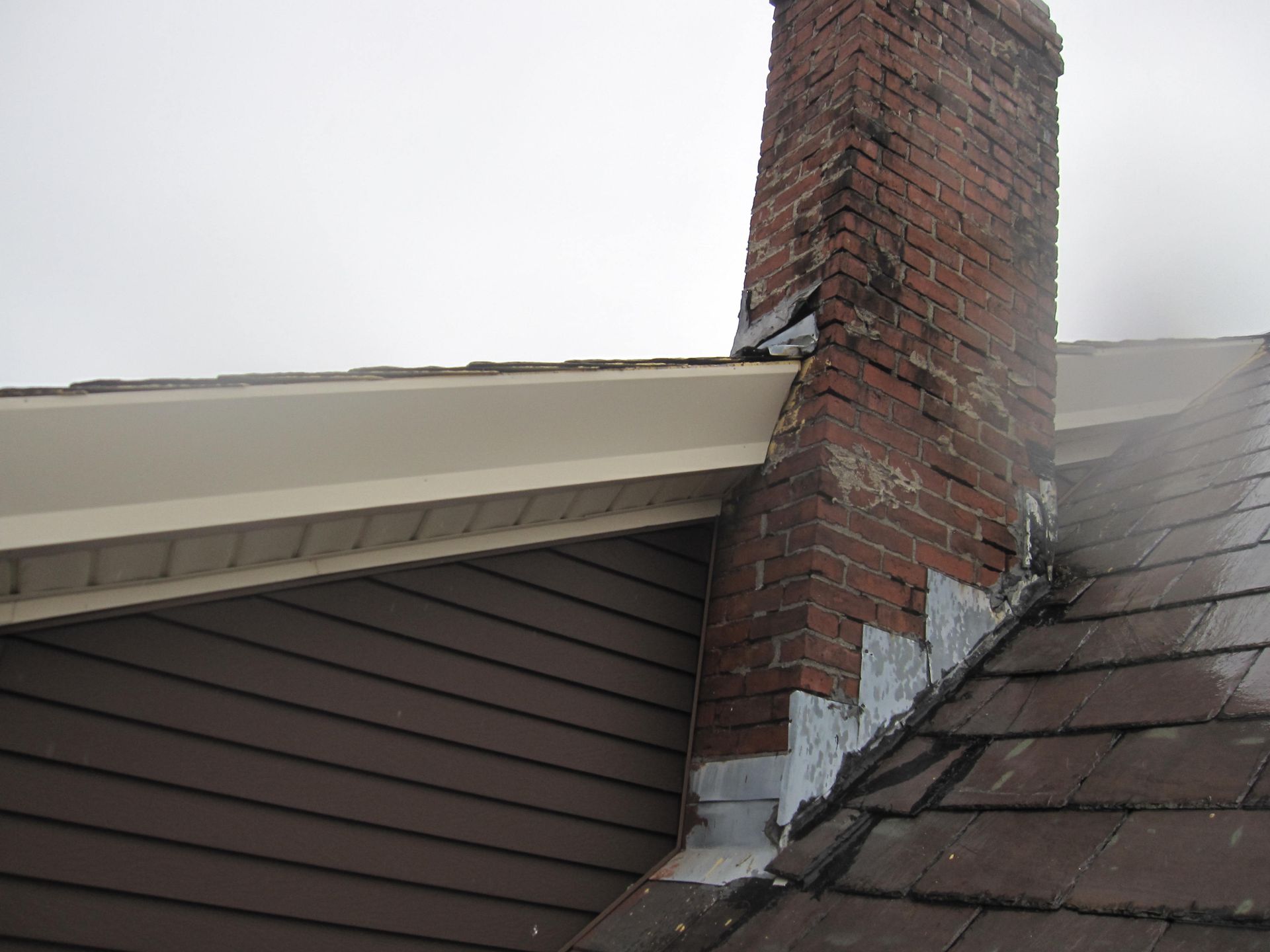 Before and after chimney repair project in Somerville, MA.