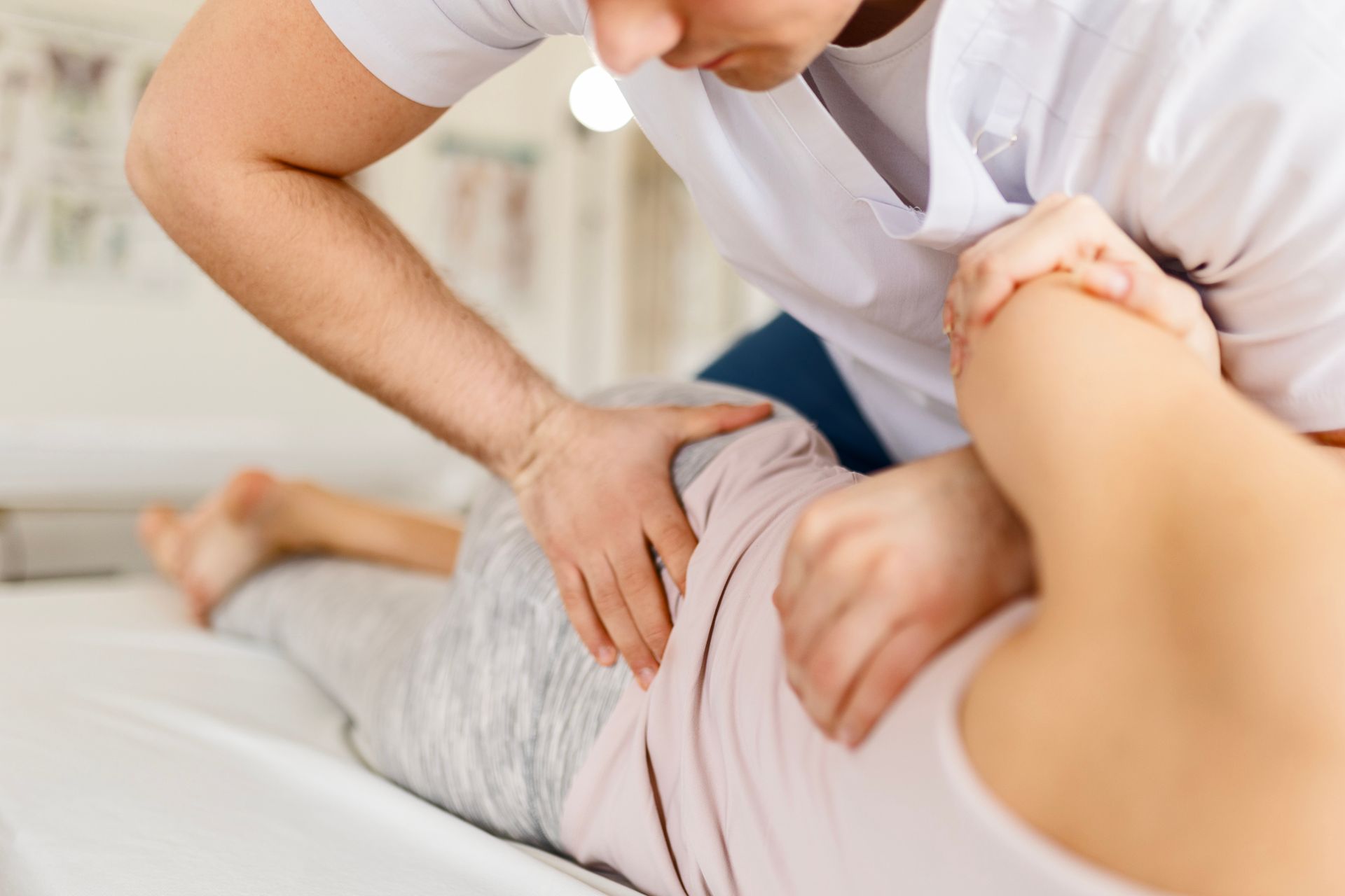 A man is giving a woman a massage on a bed.