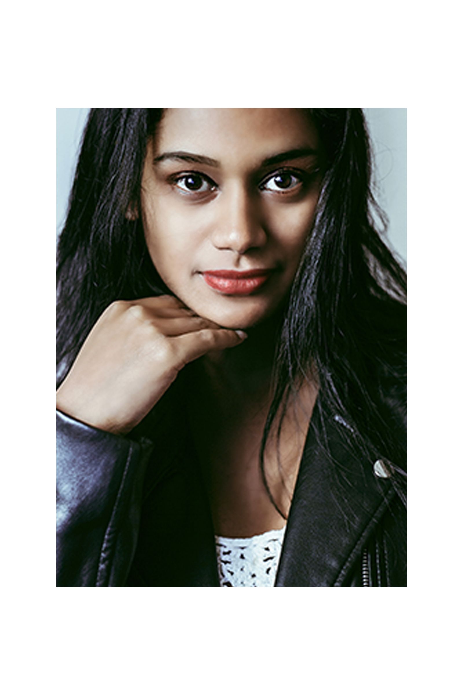 A close up of a woman wearing a leather jacket.