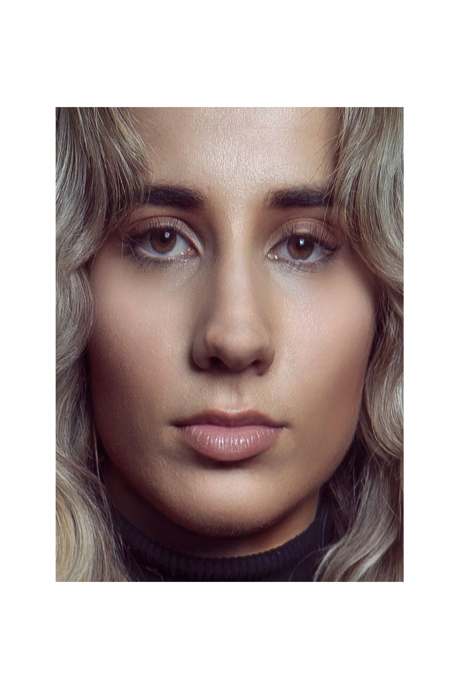 A close up of a woman 's face with a black shirt on.