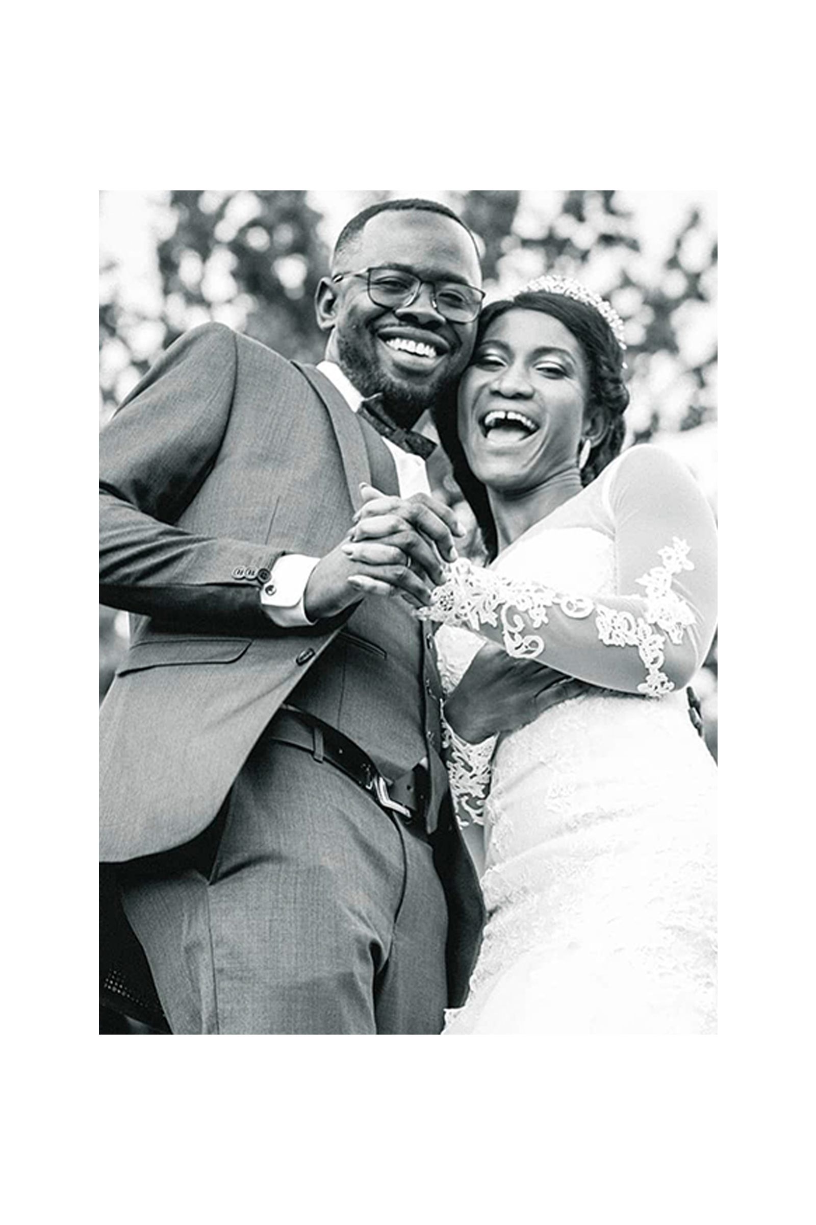 A black and white photo of a bride and groom dancing on their wedding day.