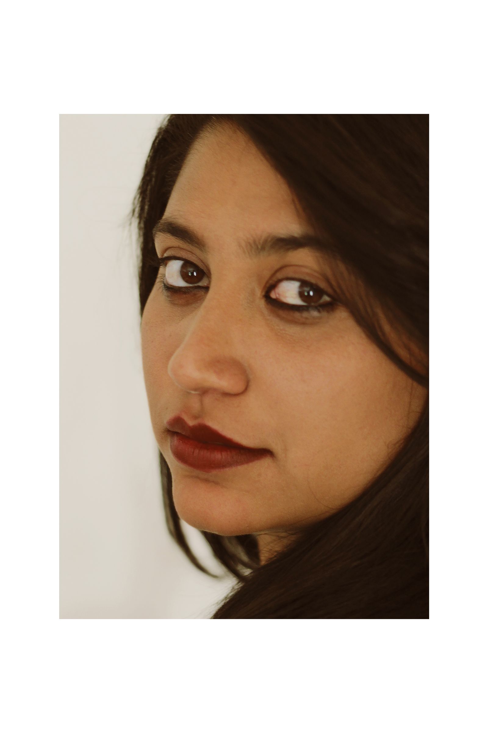 A close up of a woman 's face with a white background