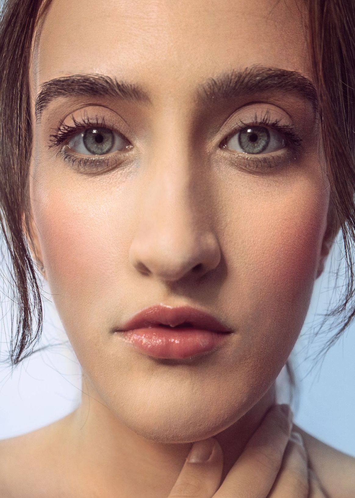 A close up of a woman 's face with makeup on.