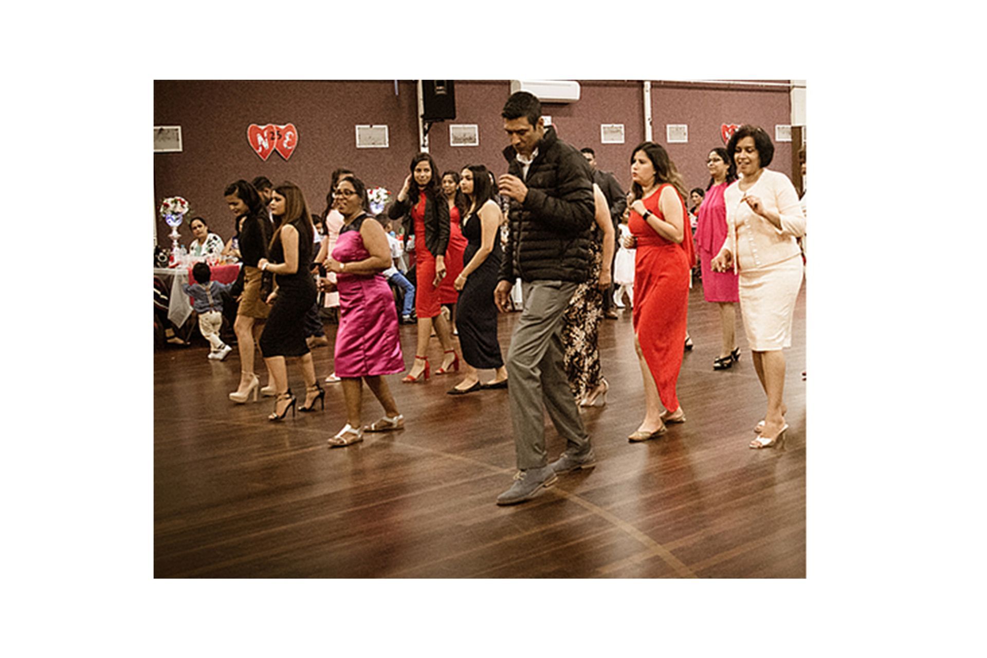 A group of people are dancing on a dance floor.