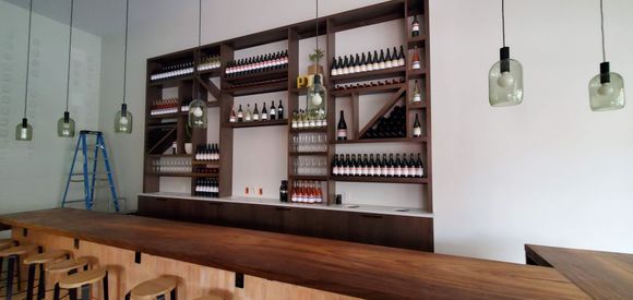 A bar with a lot of wine bottles on shelves