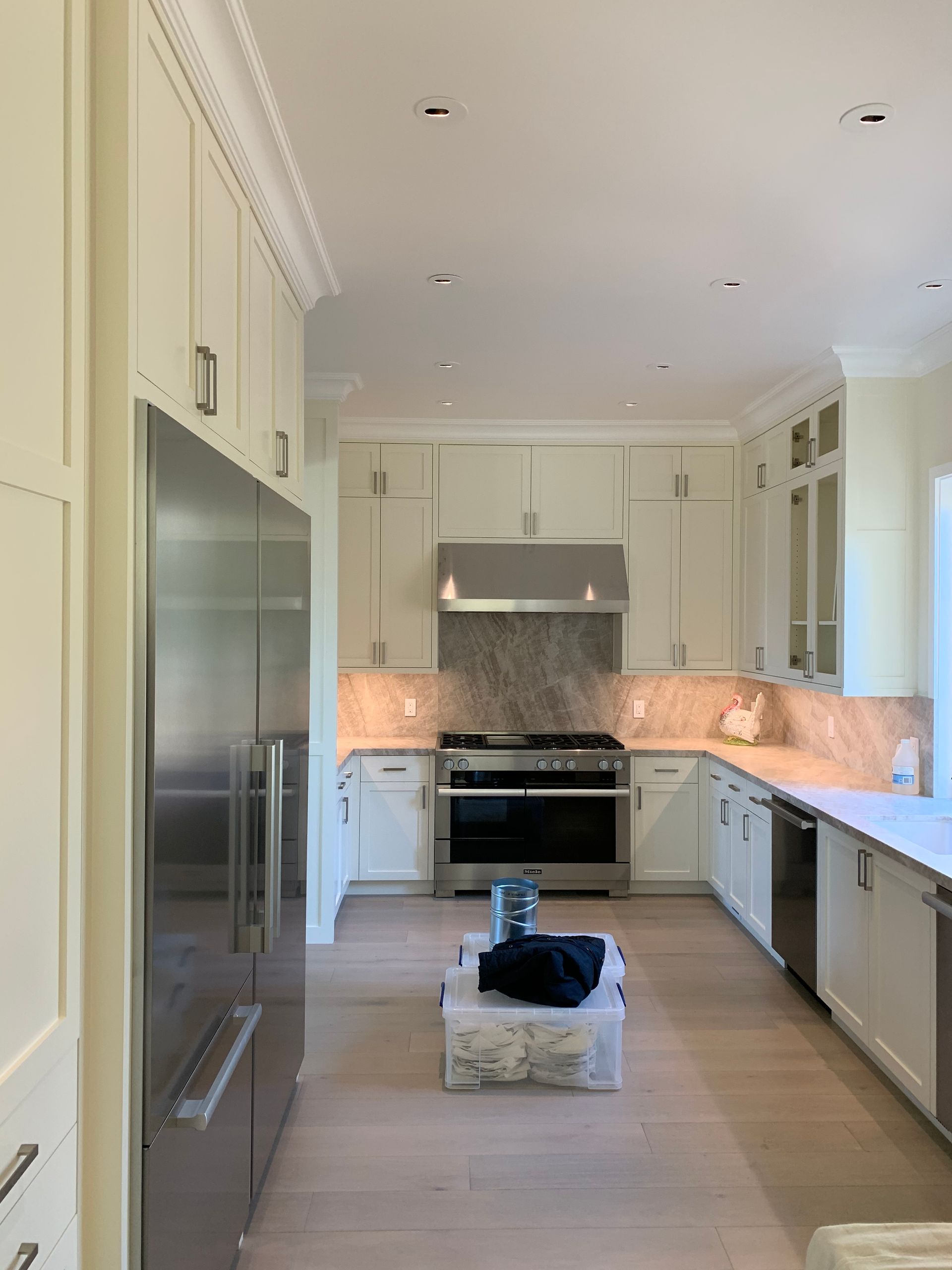 A kitchen with white cabinets and stainless steel appliances.