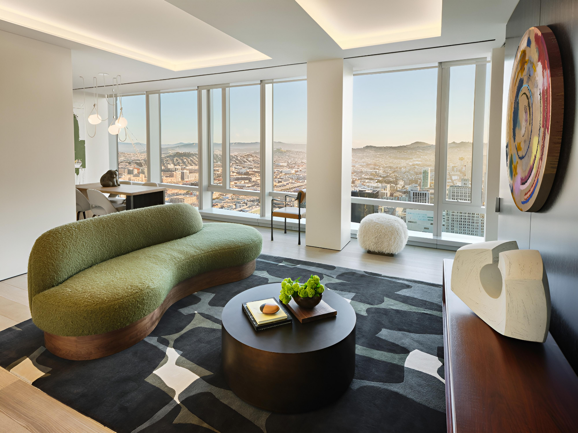 A dining room with a table and chairs and a view of the ocean