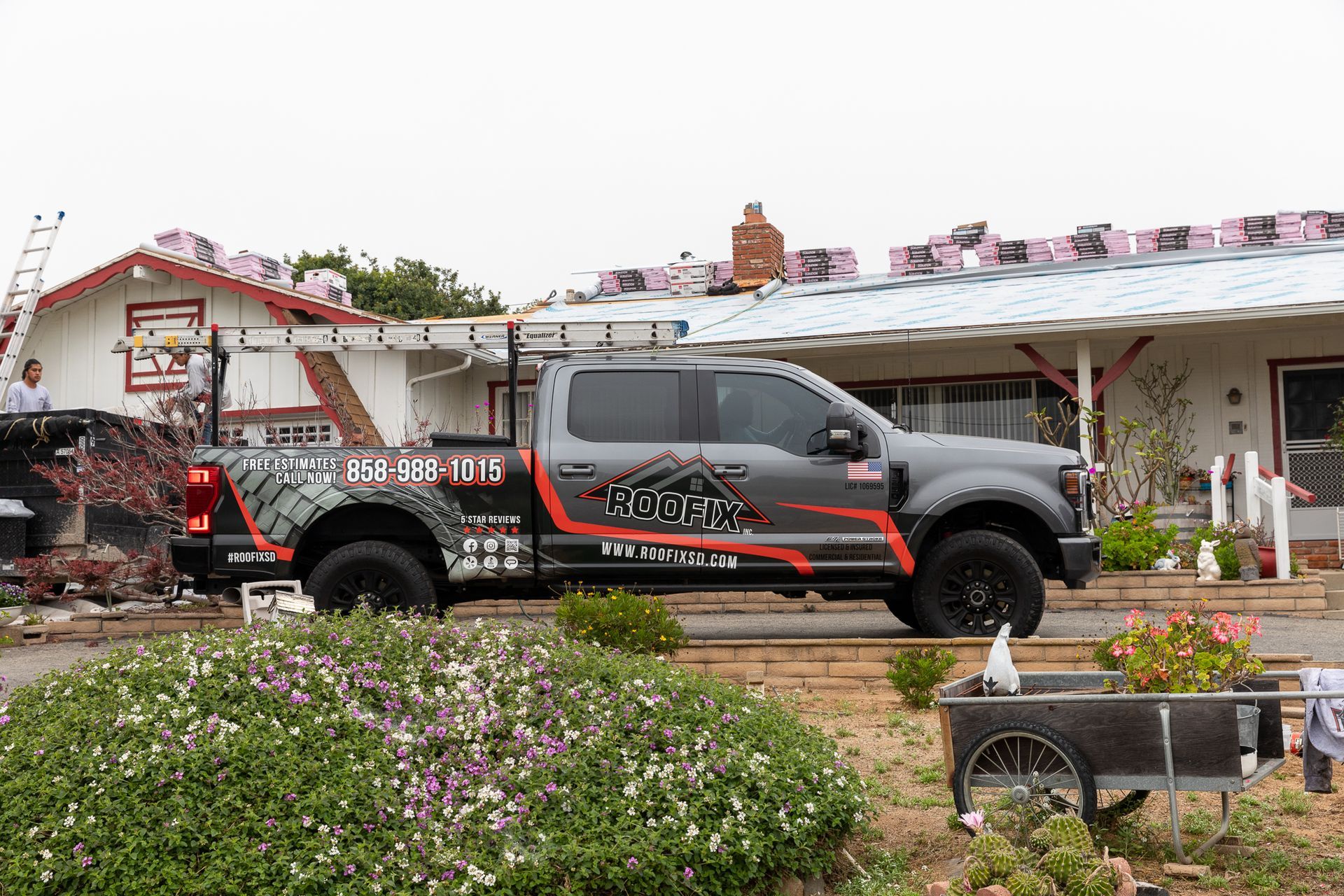A truck is parked in front of a house that is being remodeled