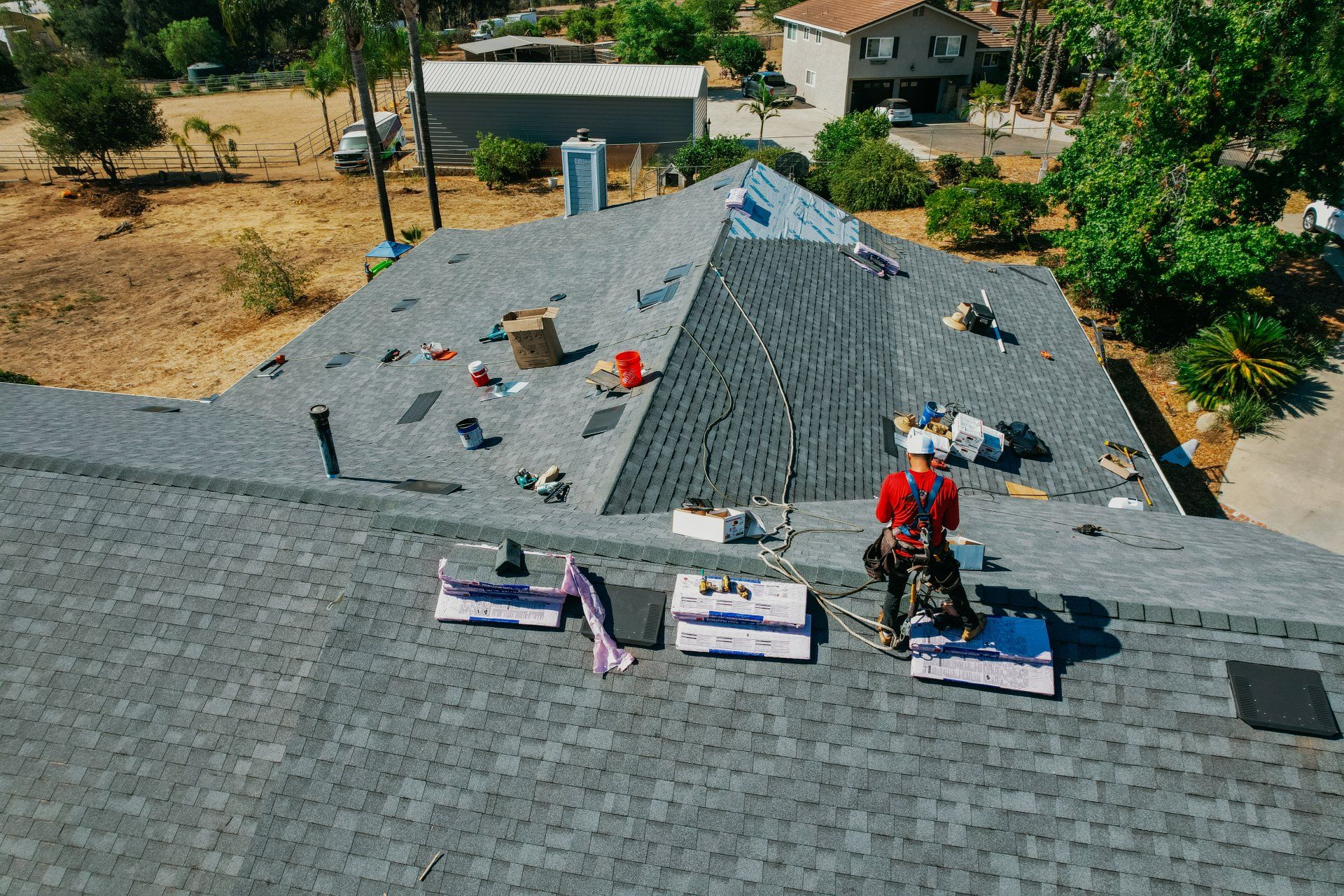 A man is working on the roof of a house
