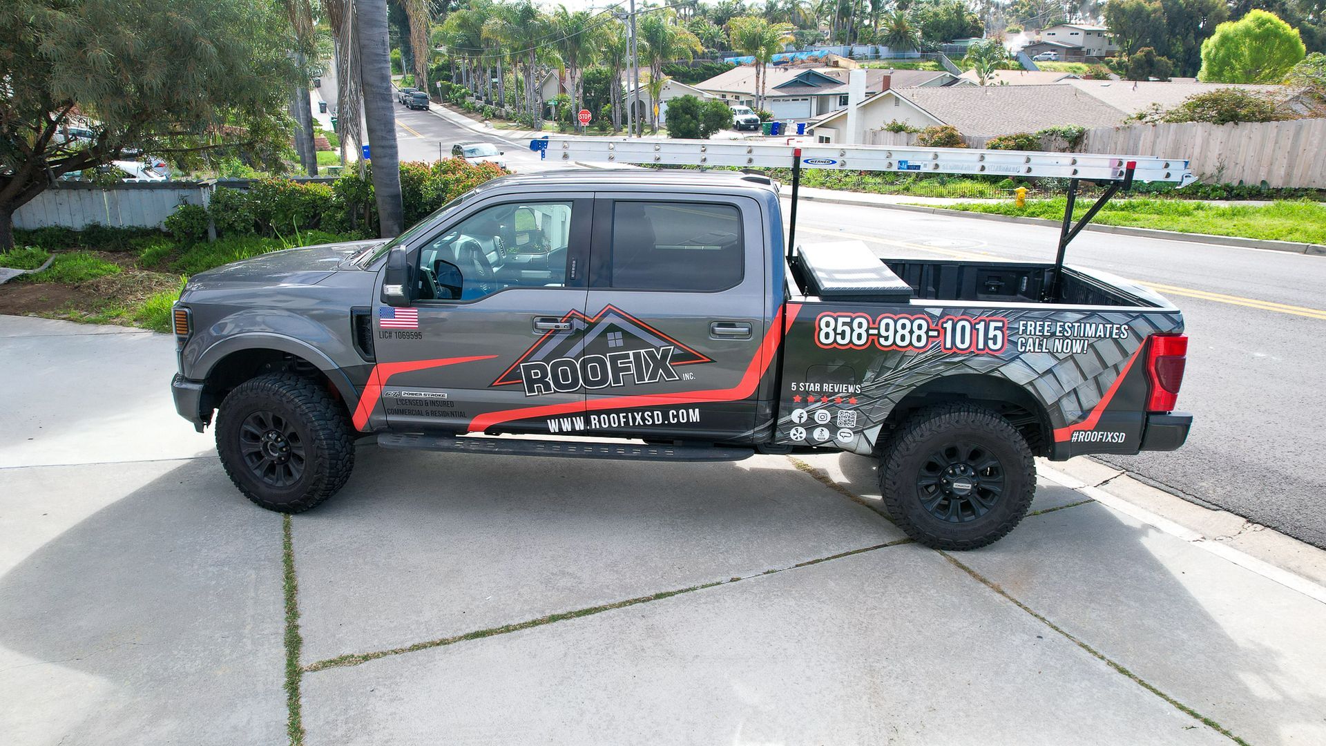 A gray truck is parked on the side of the road