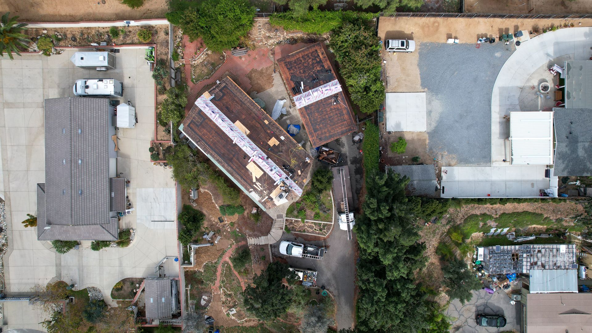 An aerial view of a residential area with houses and trees