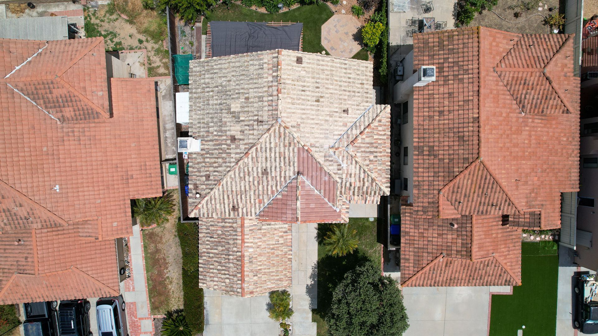 An aerial view of a residential neighborhood with red tile roofs