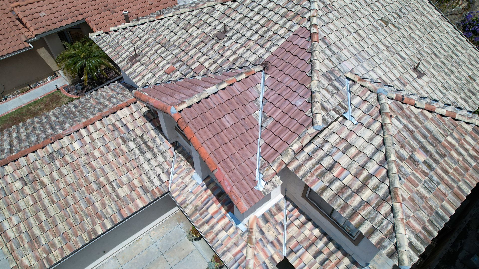 An aerial view of a tiled roof of a house