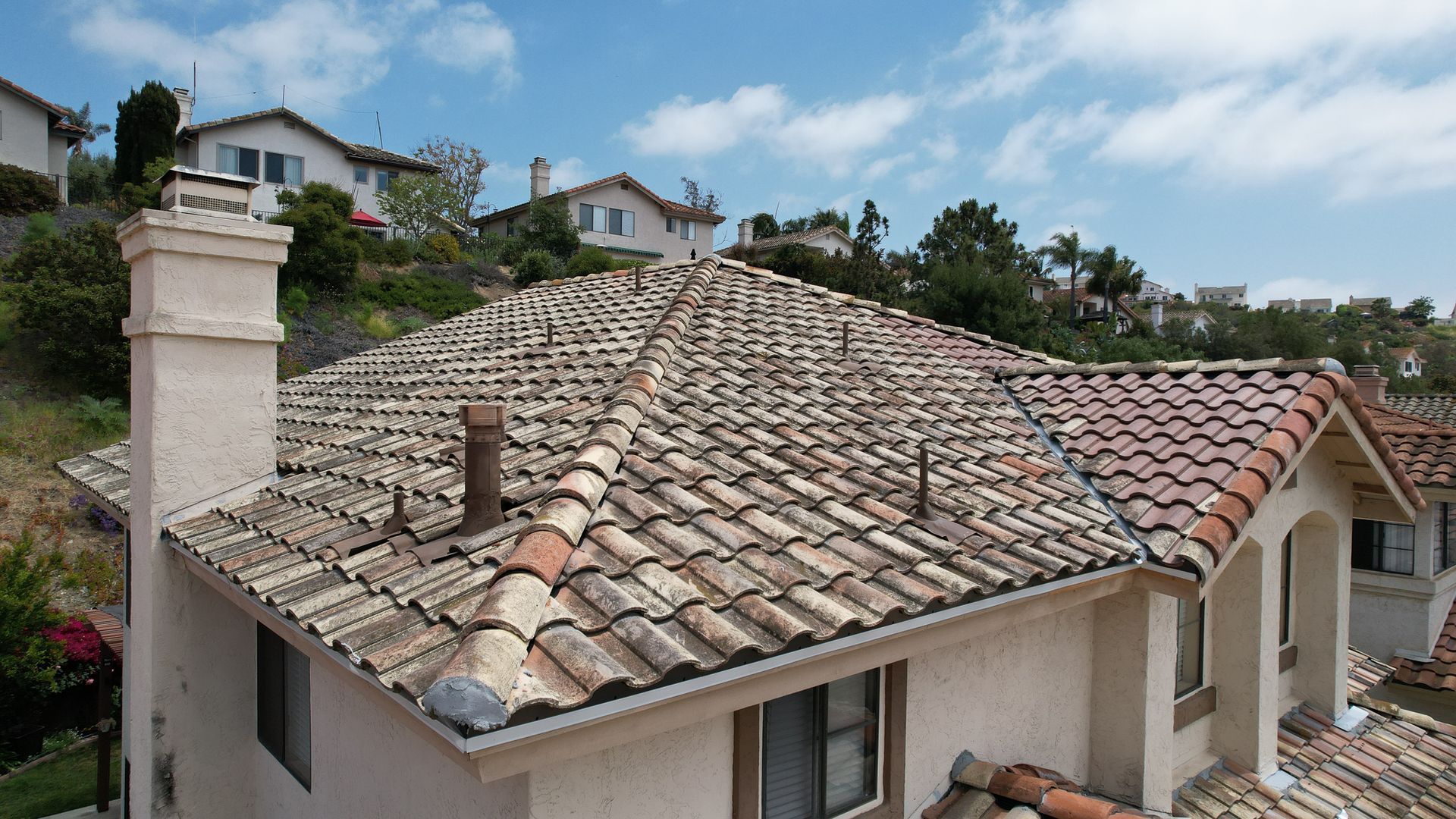 A house with a tiled roof and a chimney