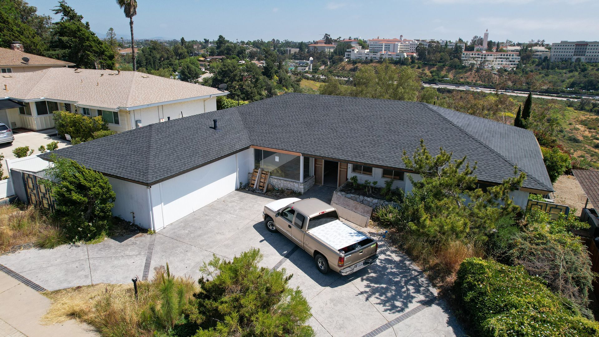 An aerial view of a house with a truck parked in front of it