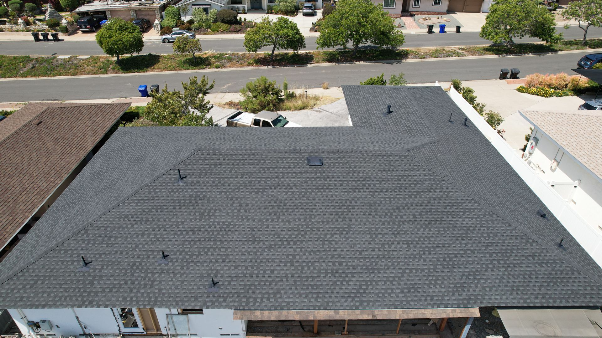 An aerial view of a house with a black roof