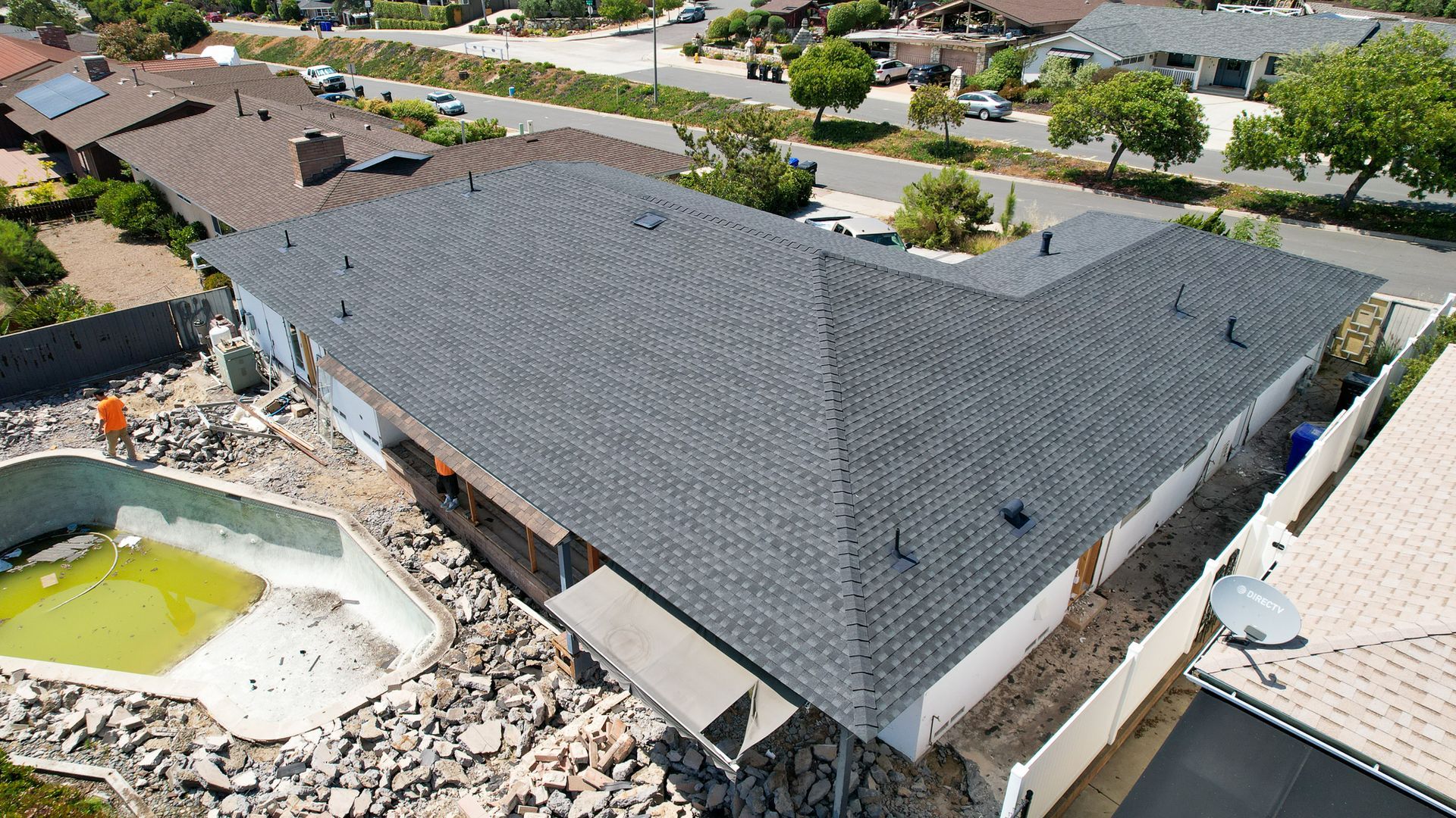 An aerial view of a house with a black roof