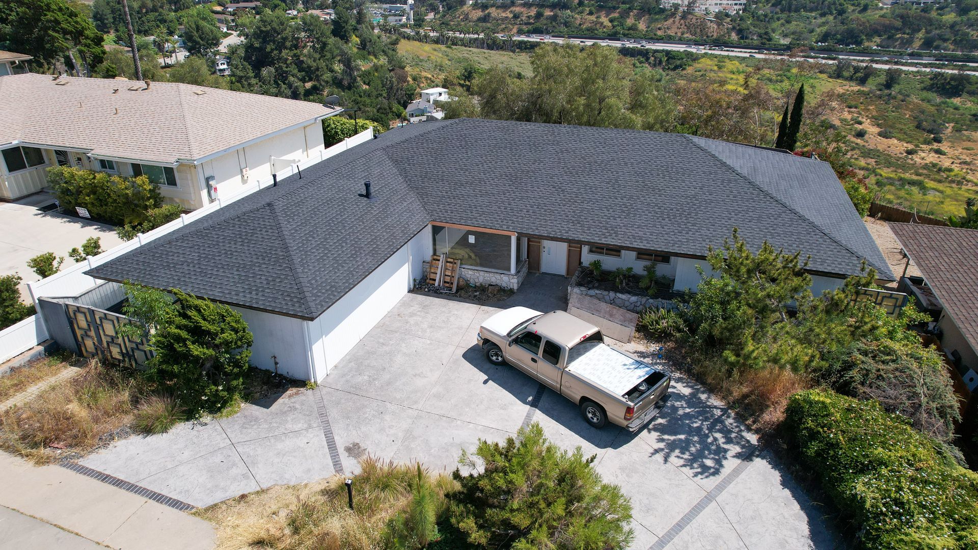An aerial view of a house with a truck parked in front of it