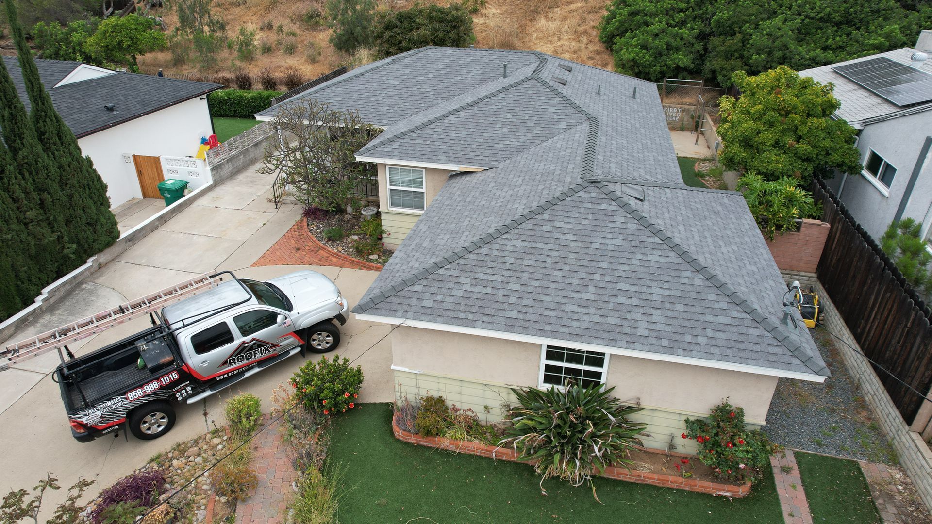 An aerial view of a house with a truck parked in front of it