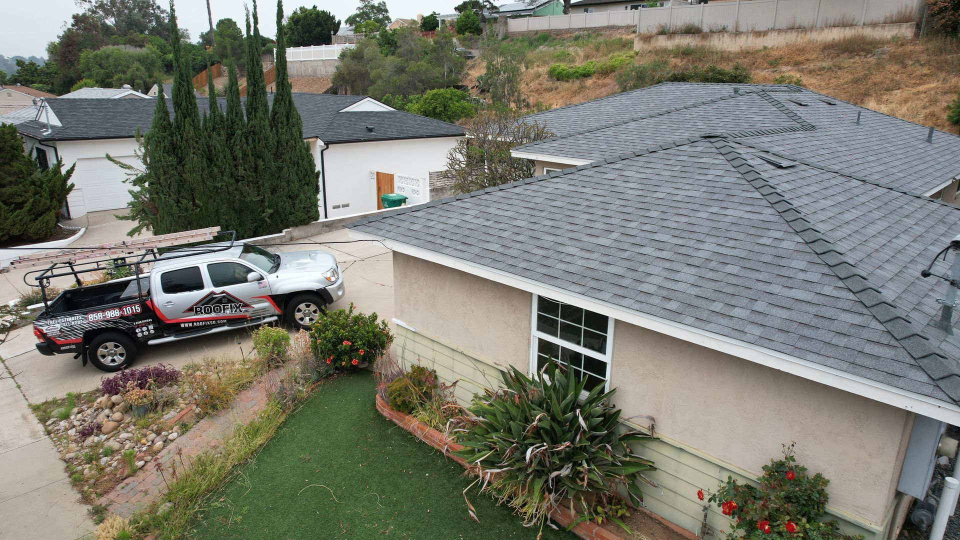 A white truck is parked in front of a house