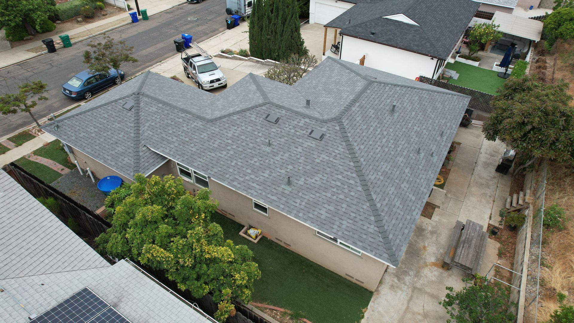 An aerial view of a house with a gray roof