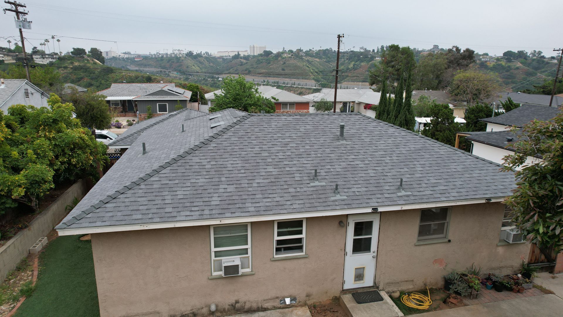 A house with a gray roof and a white door