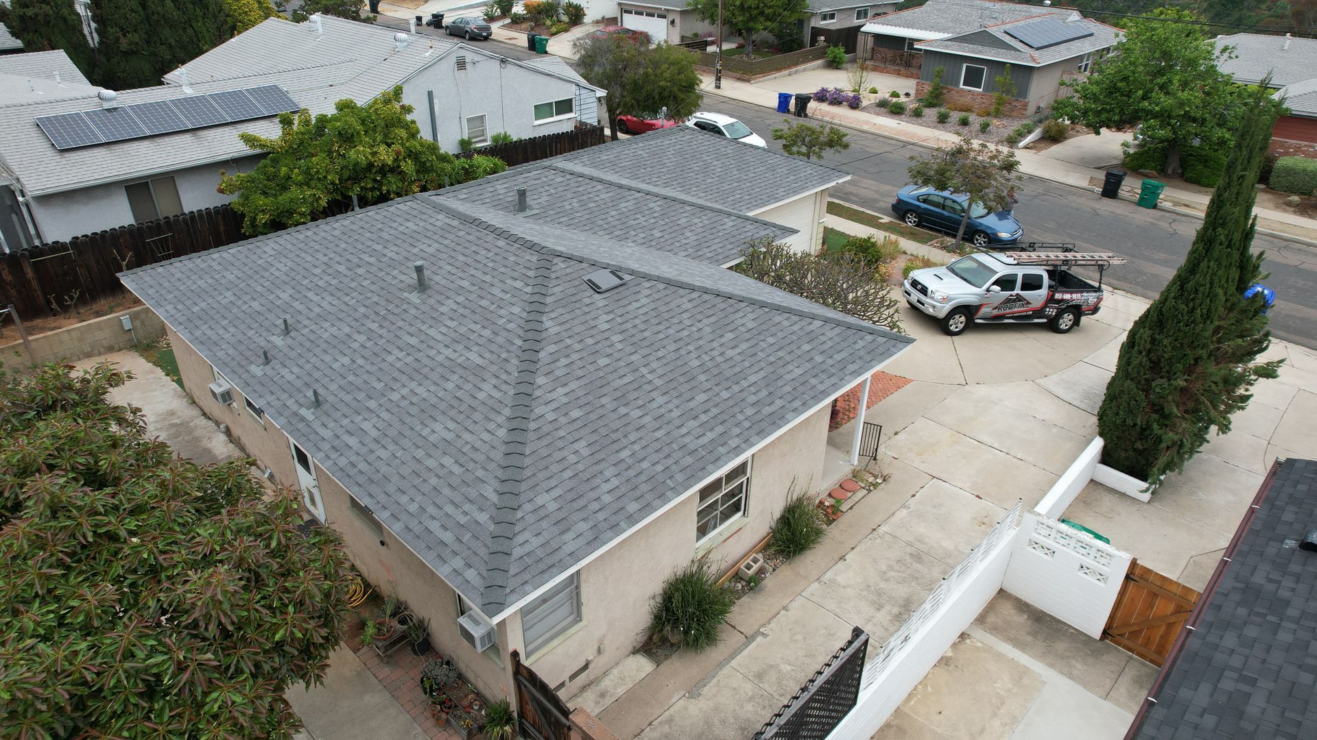 An aerial view of a house with a truck parked in front of it