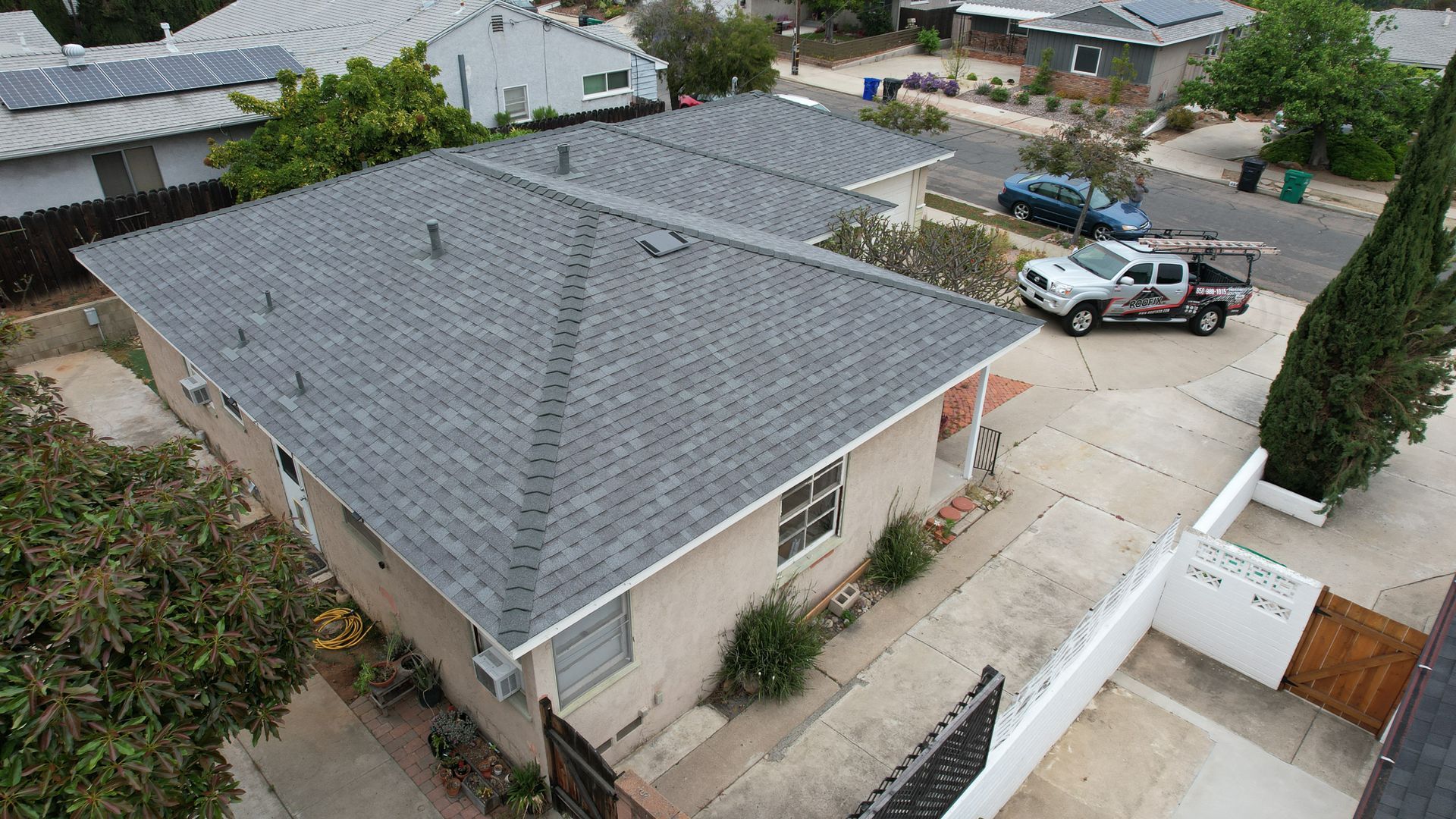 An aerial view of a house with a truck parked in front of it