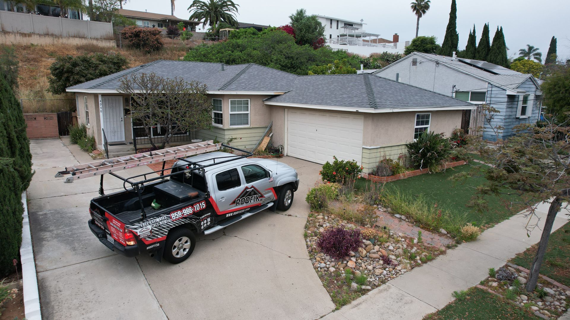 A truck is parked in the driveway of a house