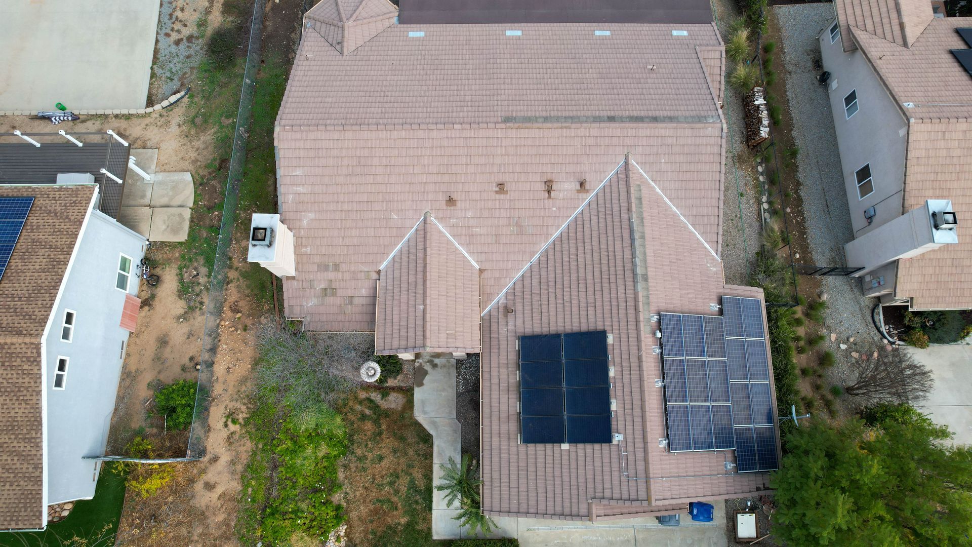 An aerial view of a house with solar panels on the roof