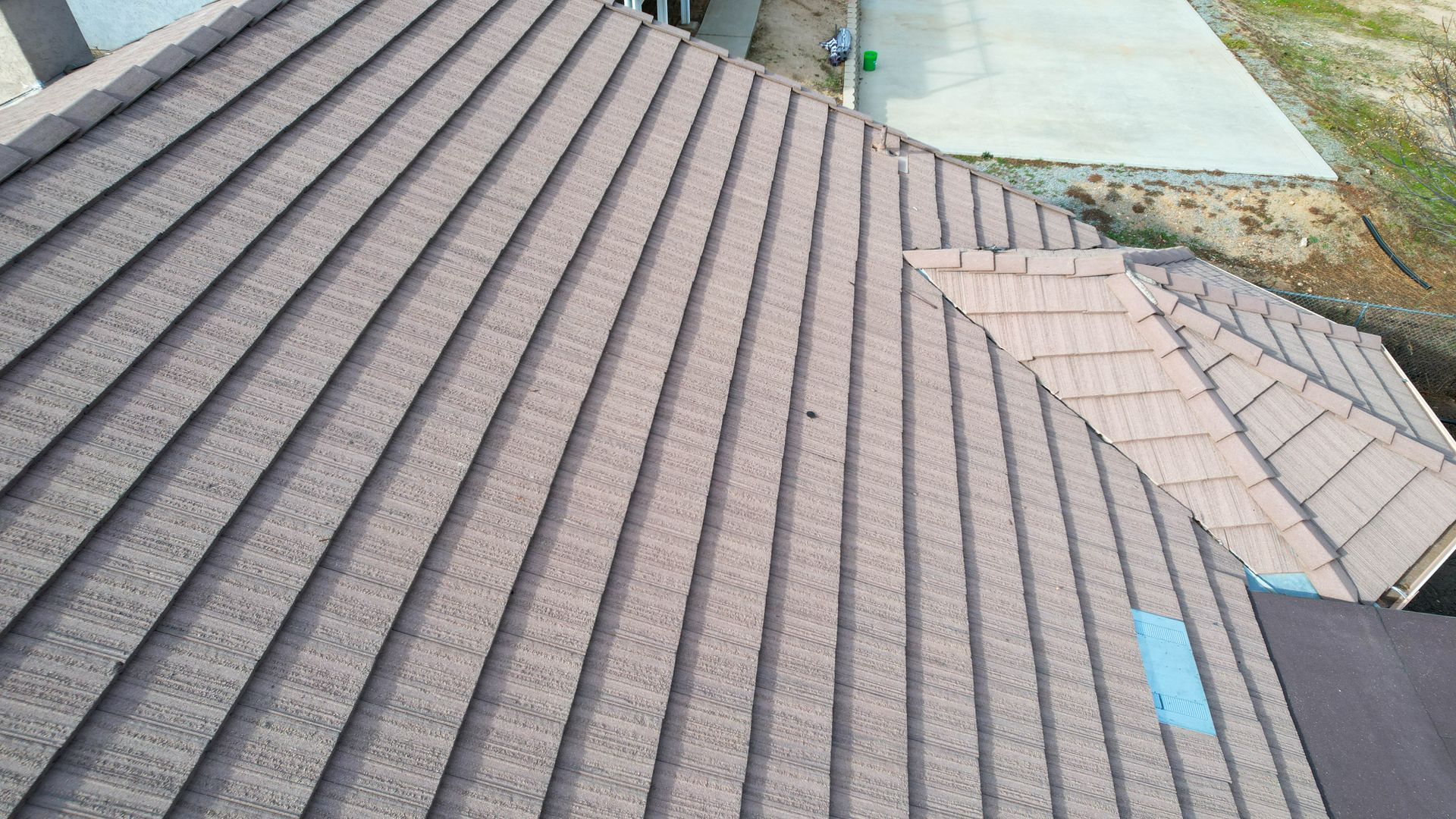 An aerial view of a roof with a blue sticker on it