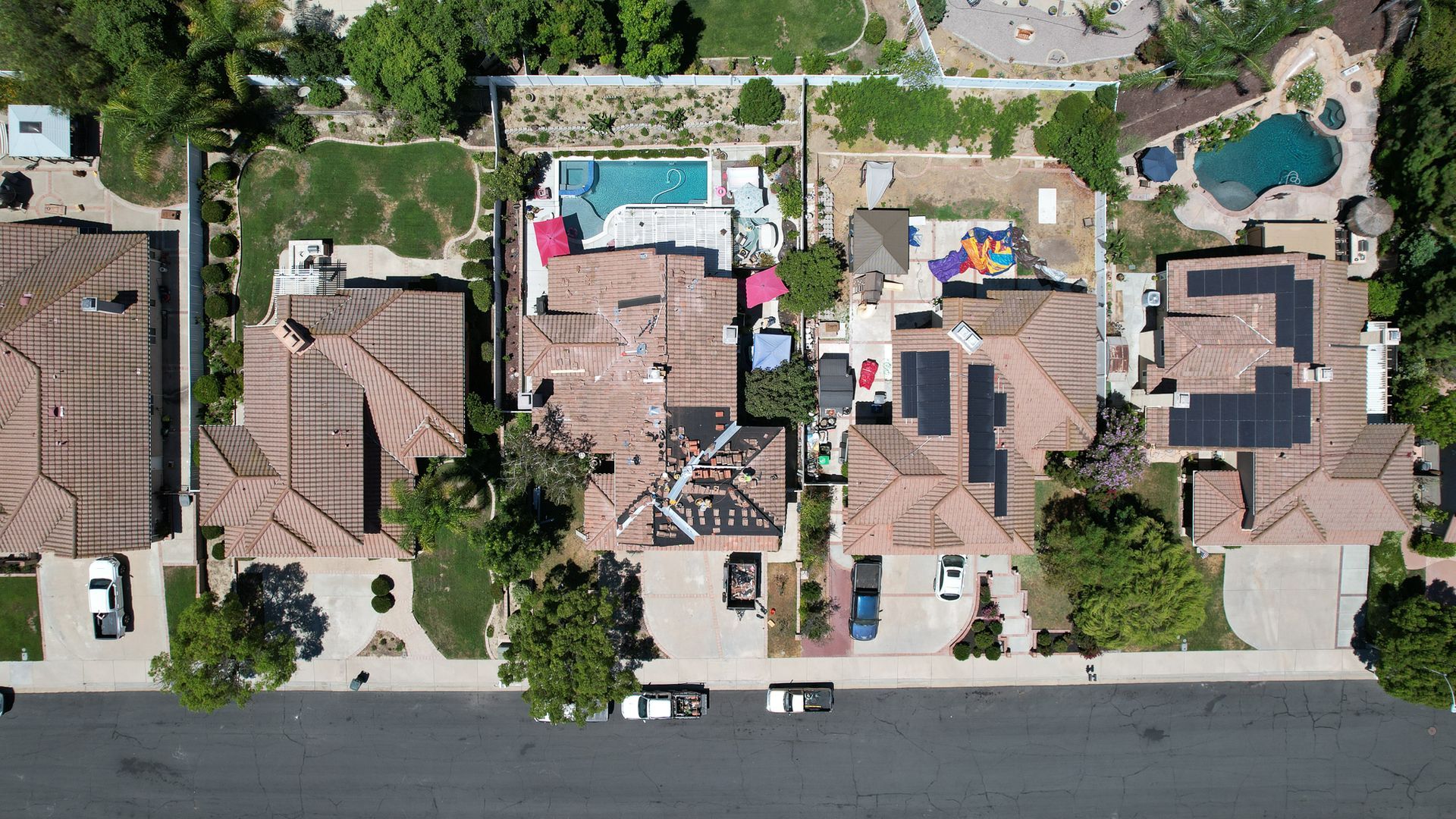 An aerial view of a residential area with houses and a pool