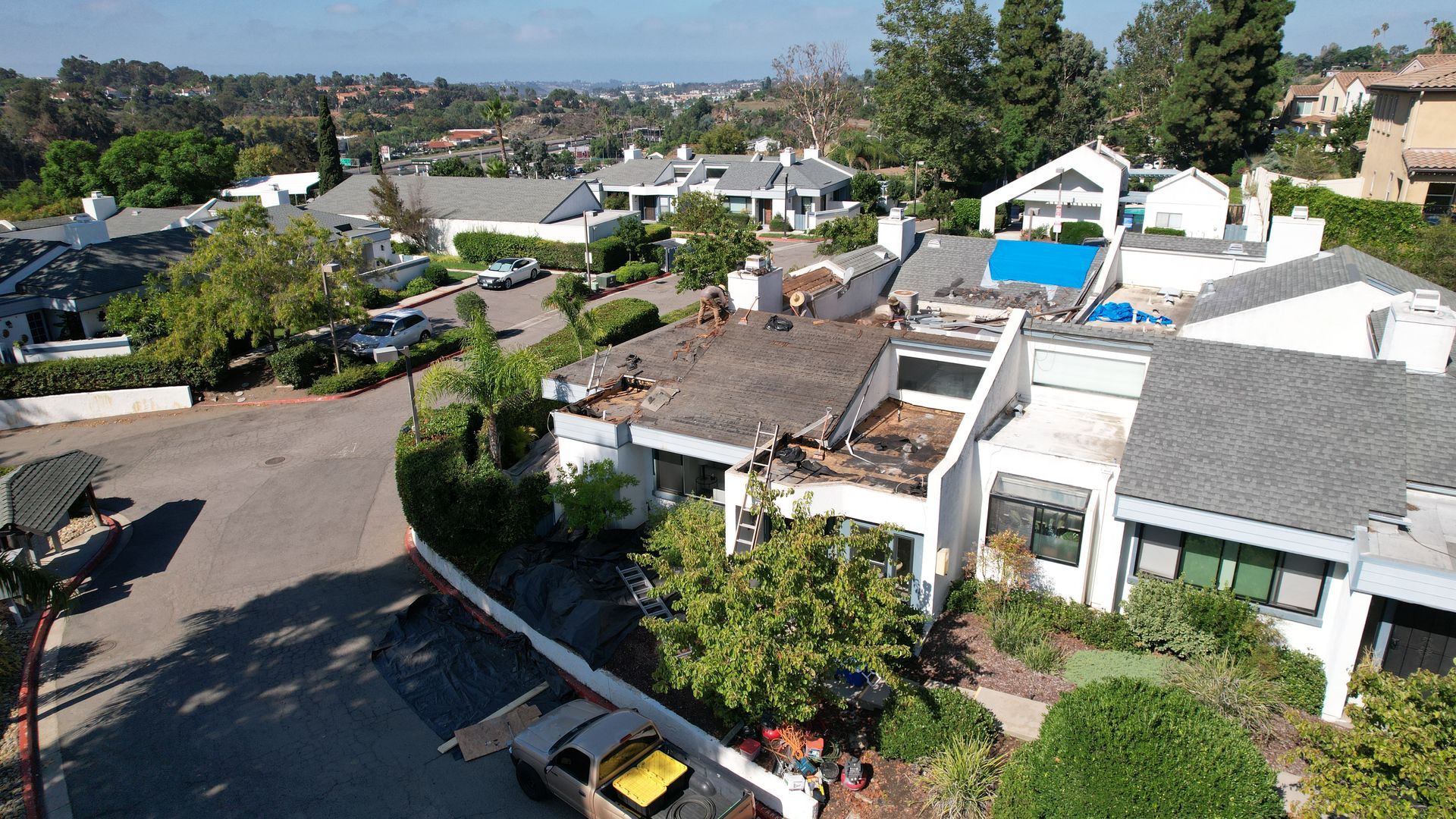 An aerial view of a residential area with houses and trees