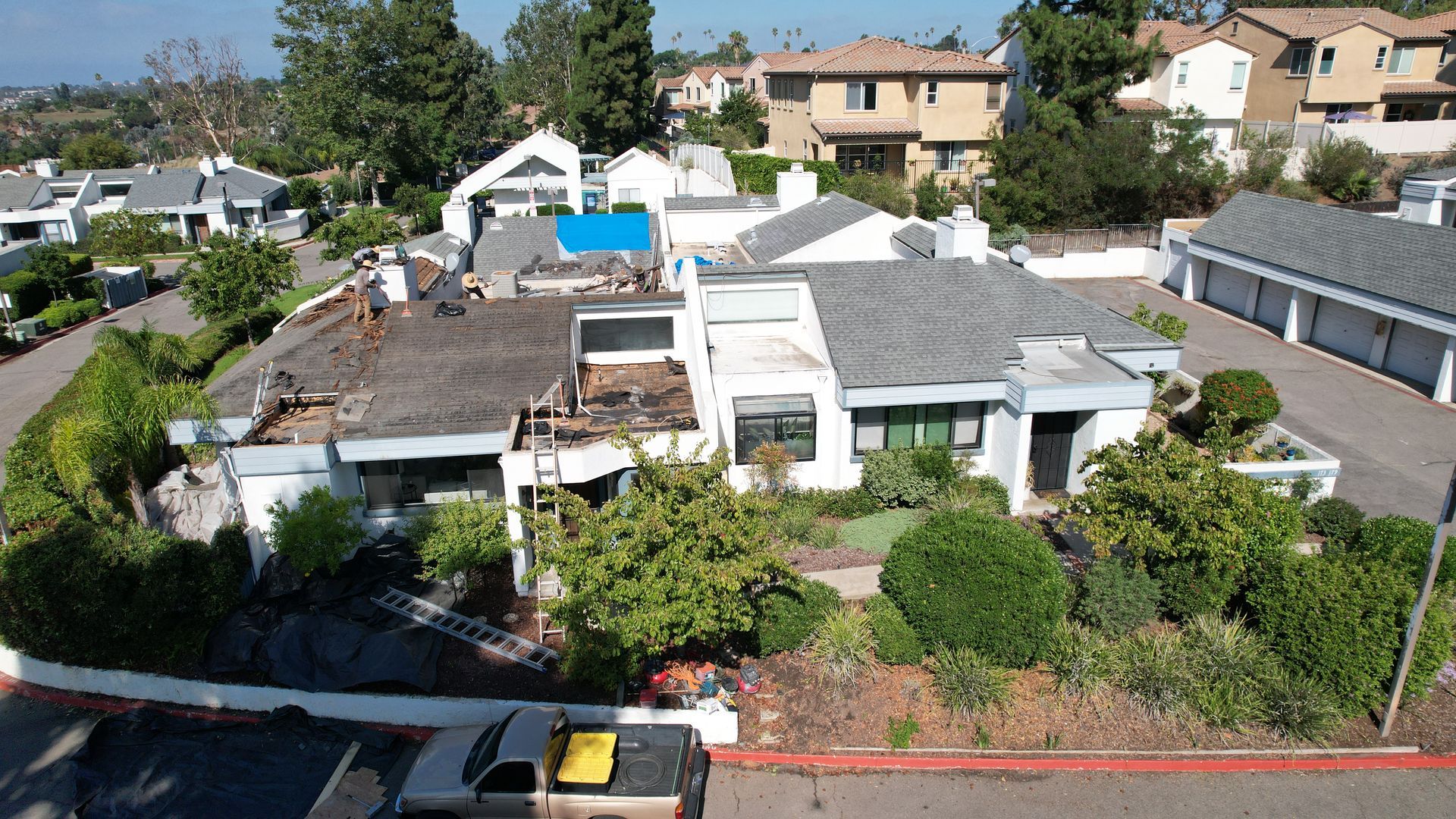 An aerial view of a house with a truck parked in front of it