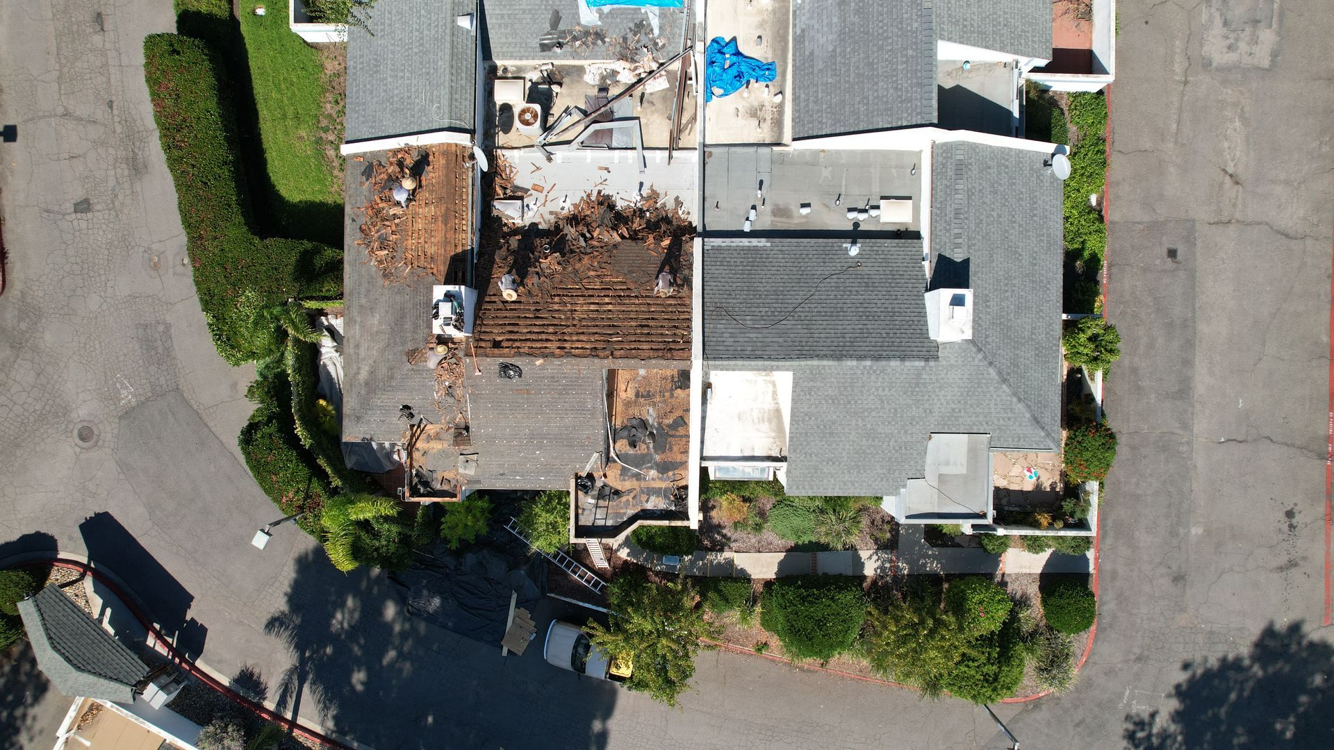 An aerial view of a house that is being demolished