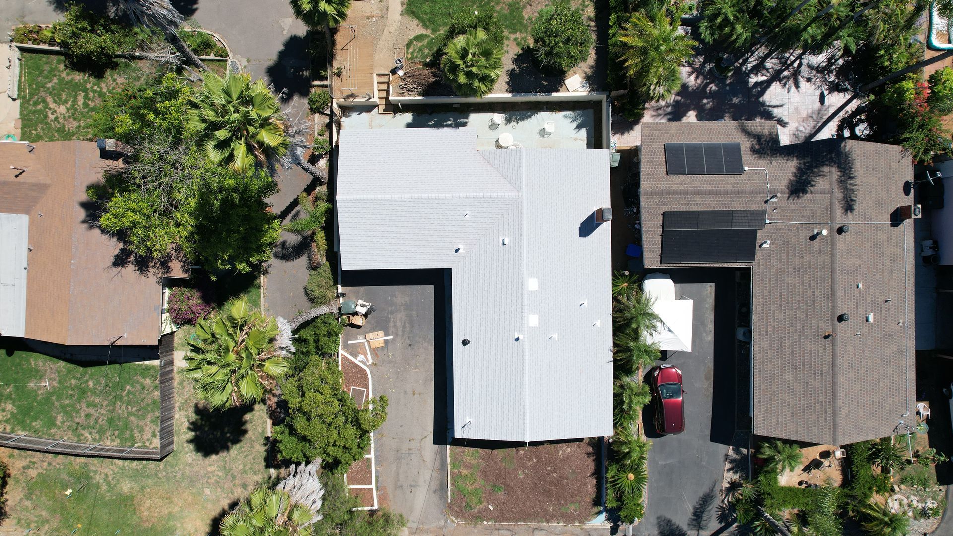 An aerial view of a residential area with houses and trees