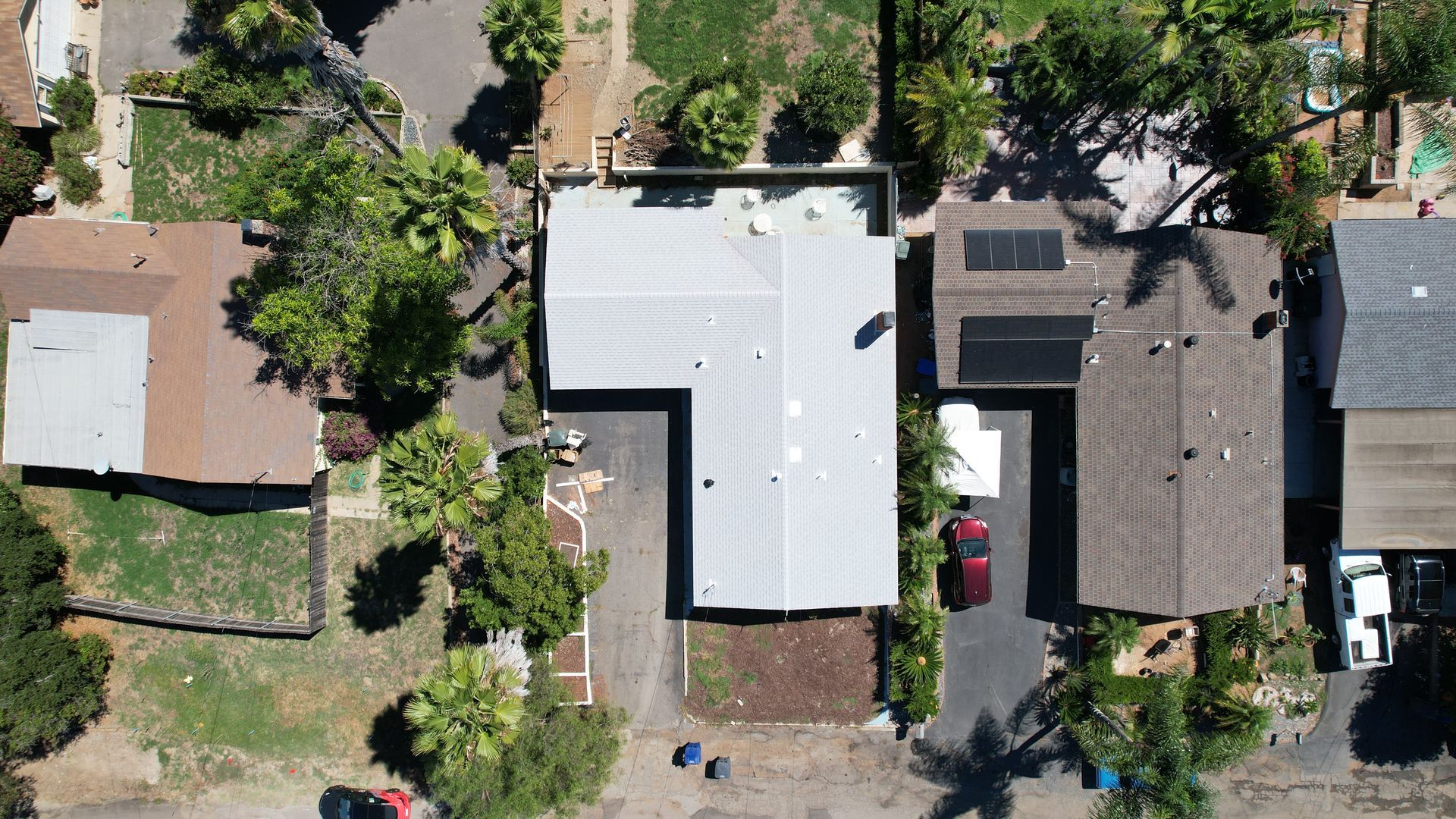 An aerial view of a residential area with houses and trees