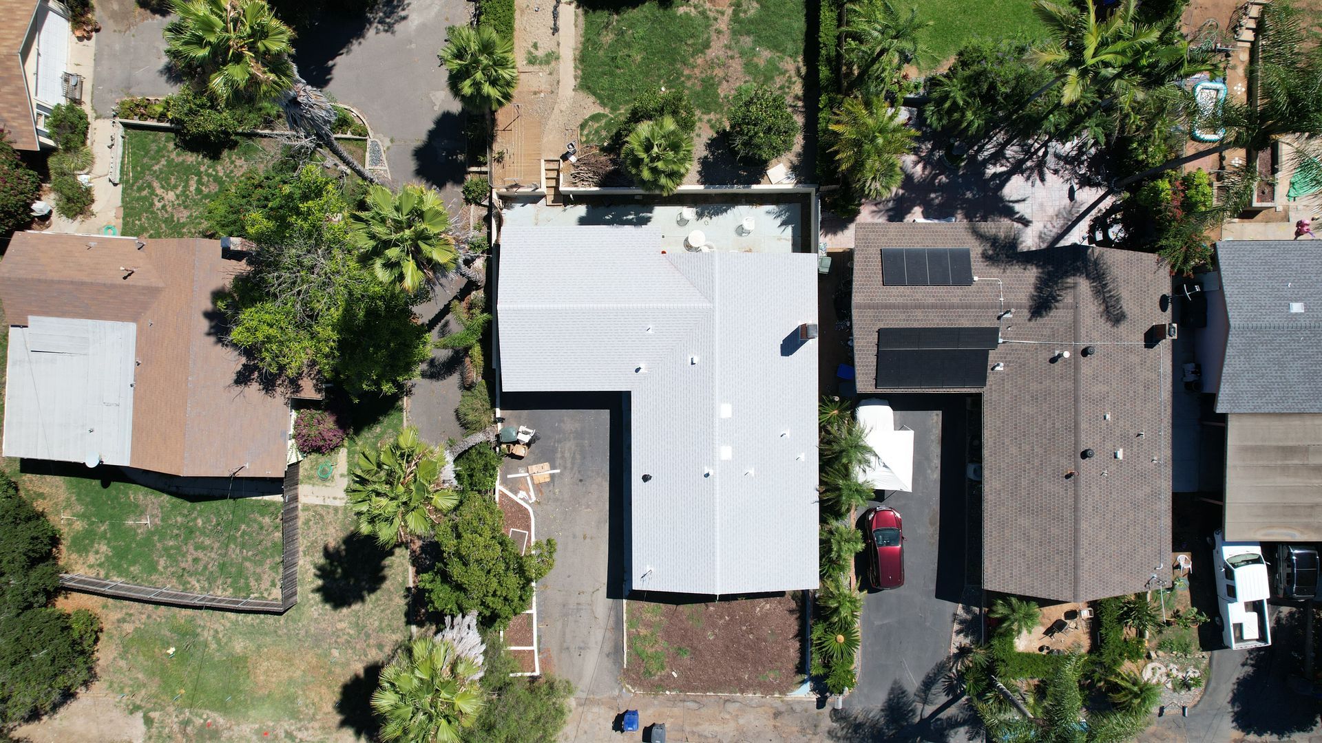 An aerial view of a house with solar panels on the roof