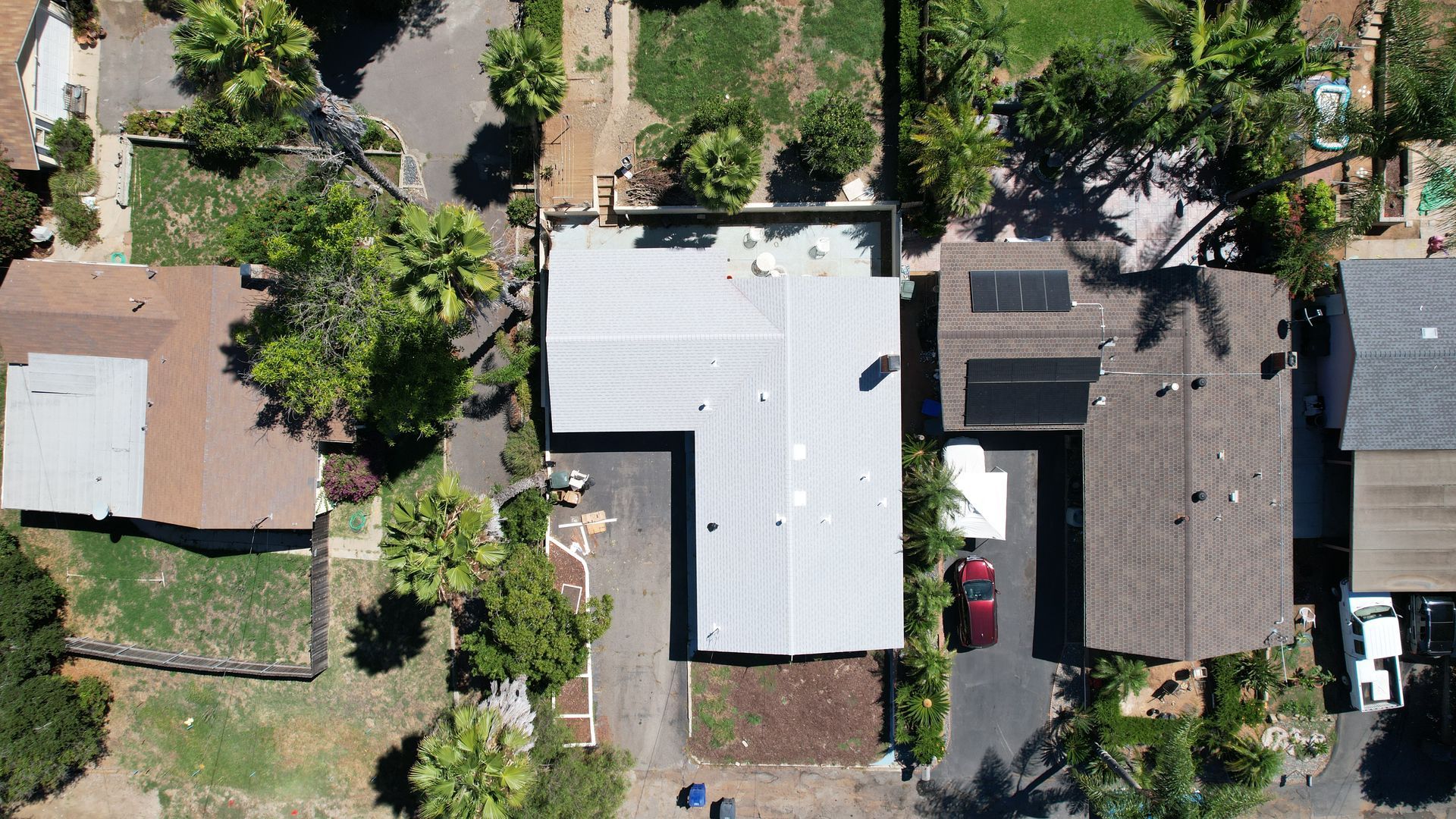 An aerial view of a residential area with houses and trees