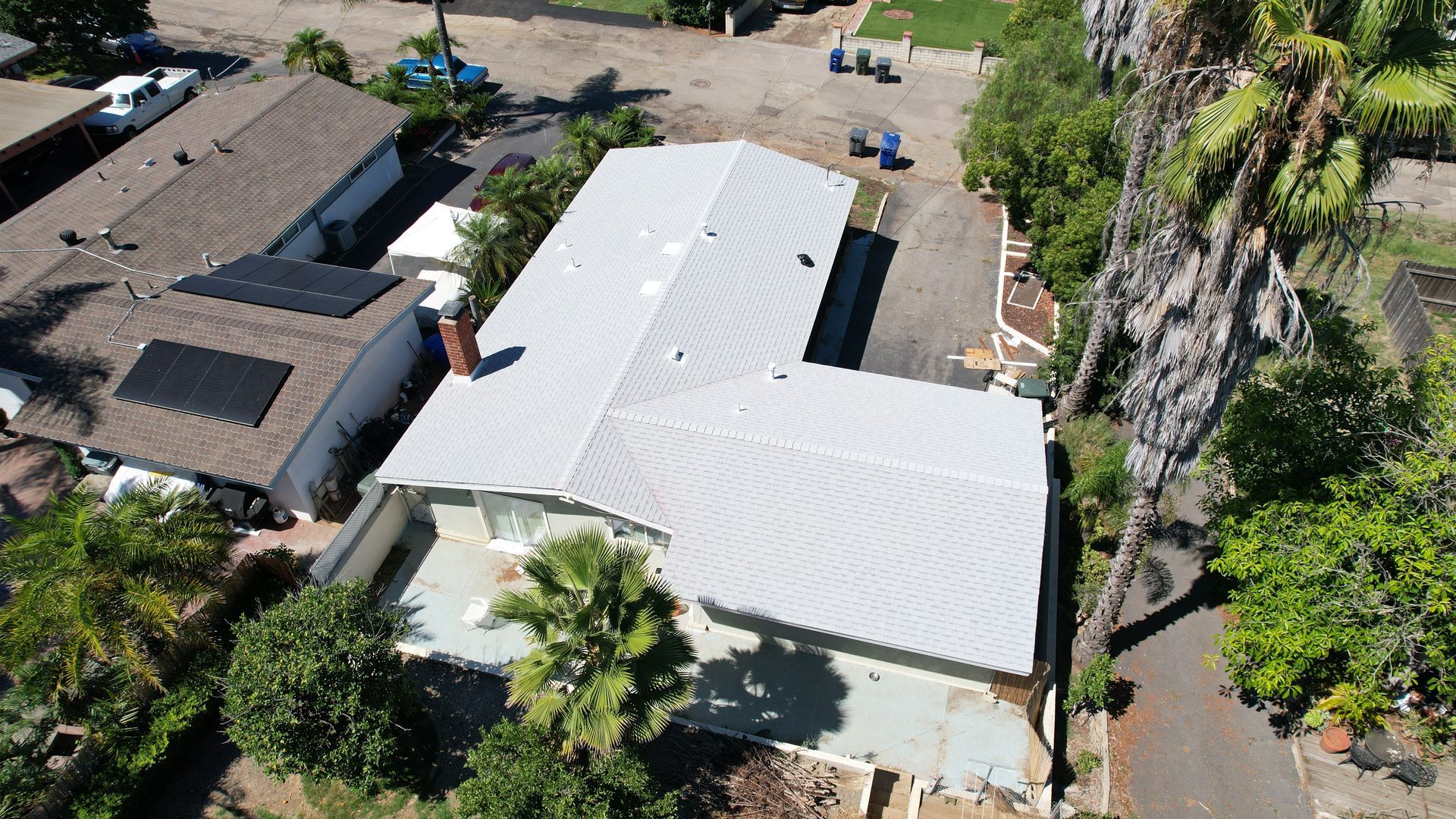 An aerial view of a house with solar panels on the roof