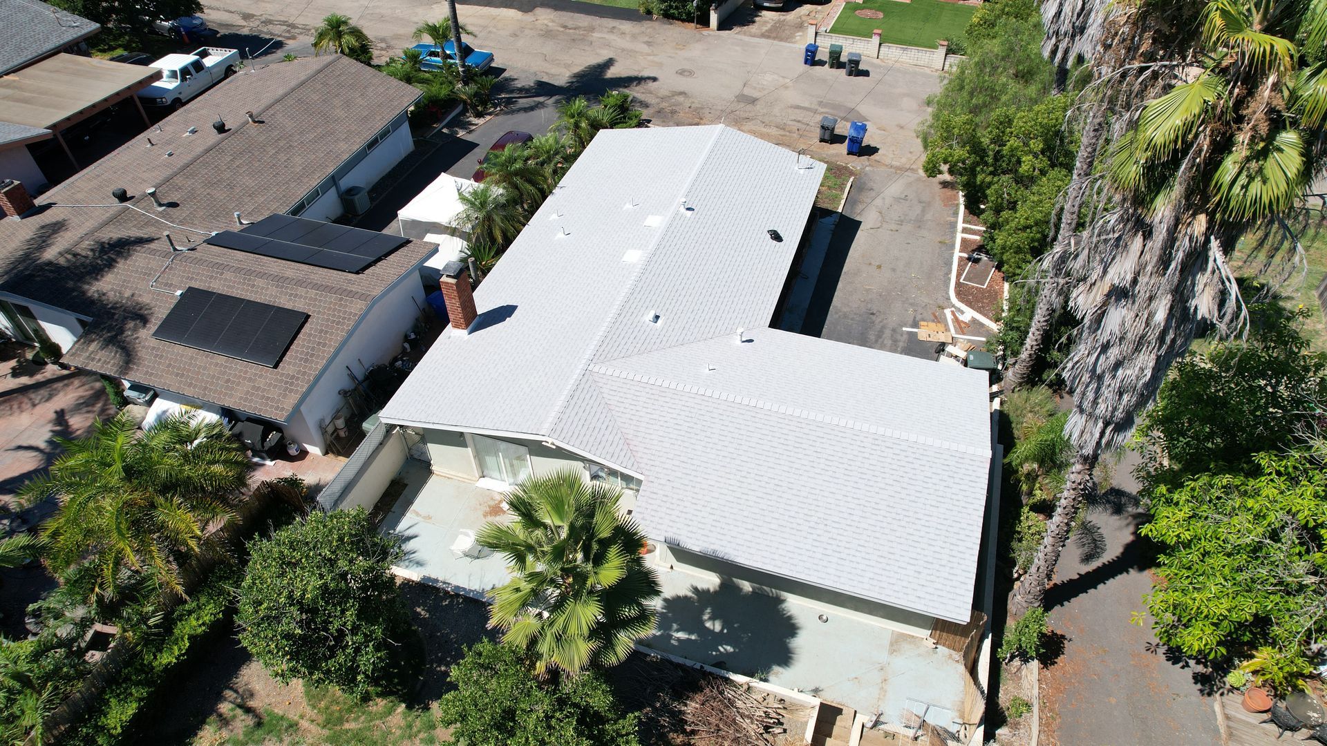 An aerial view of a house with solar panels on the roof
