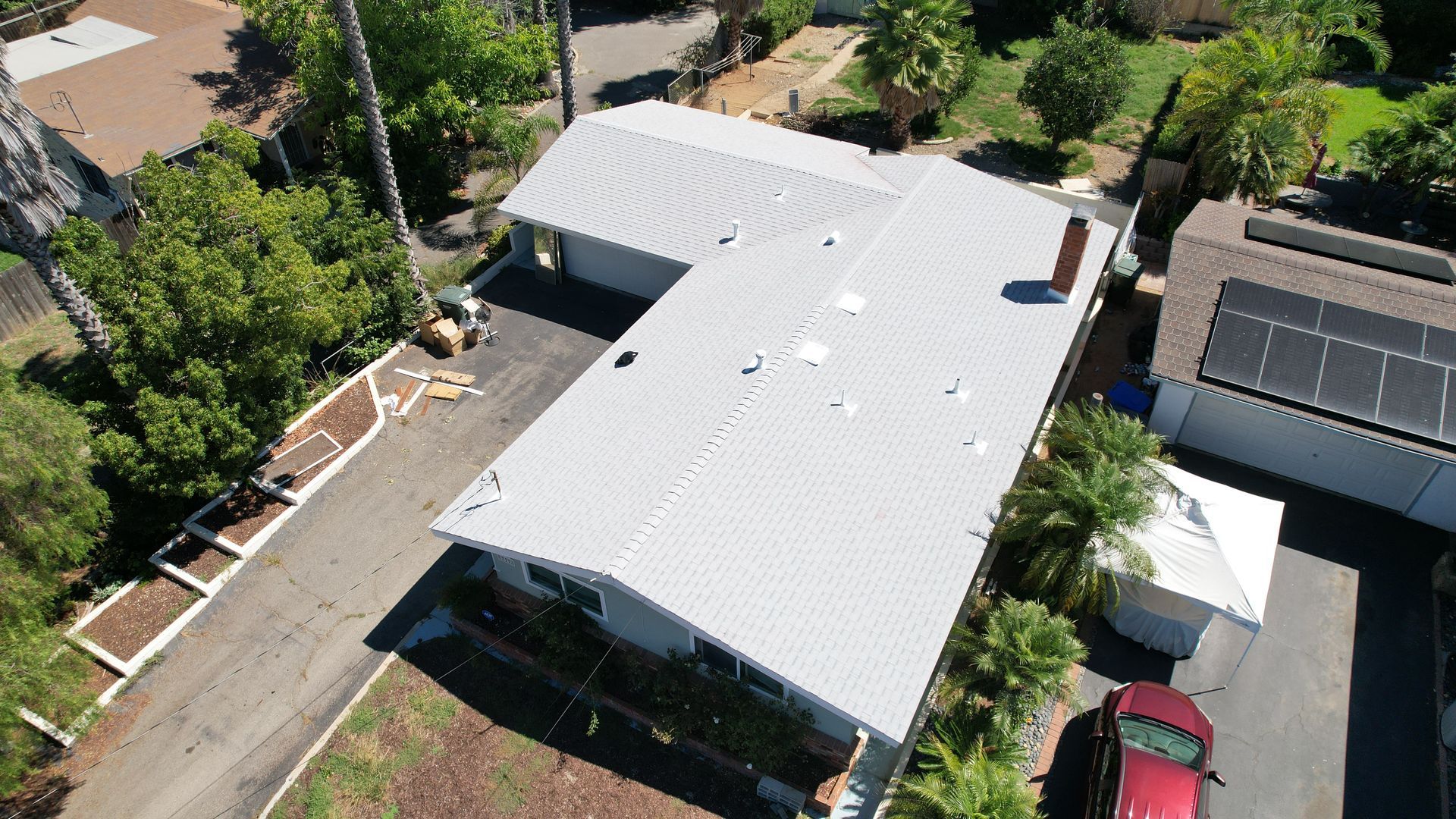 An aerial view of a house with a white roof