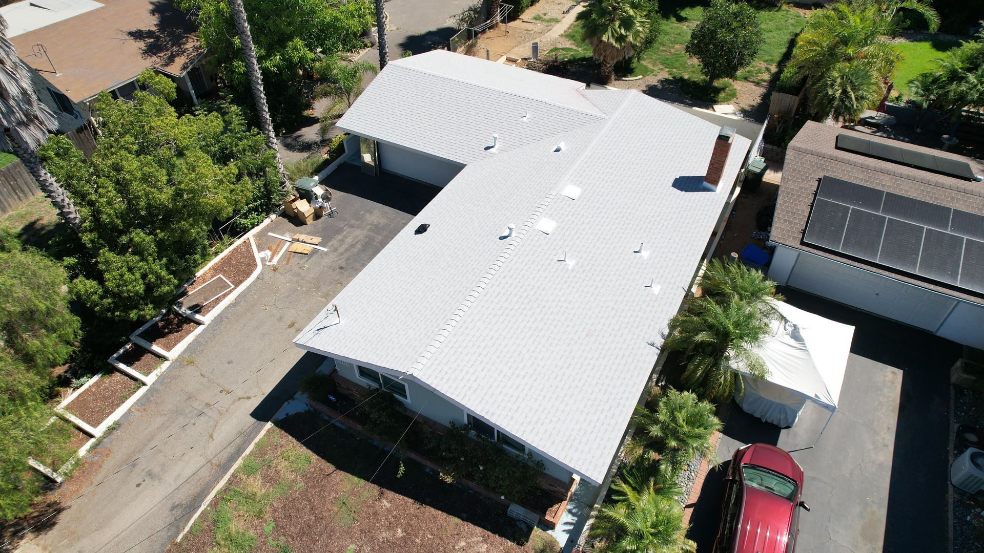 An aerial view of a house with solar panels on the roof