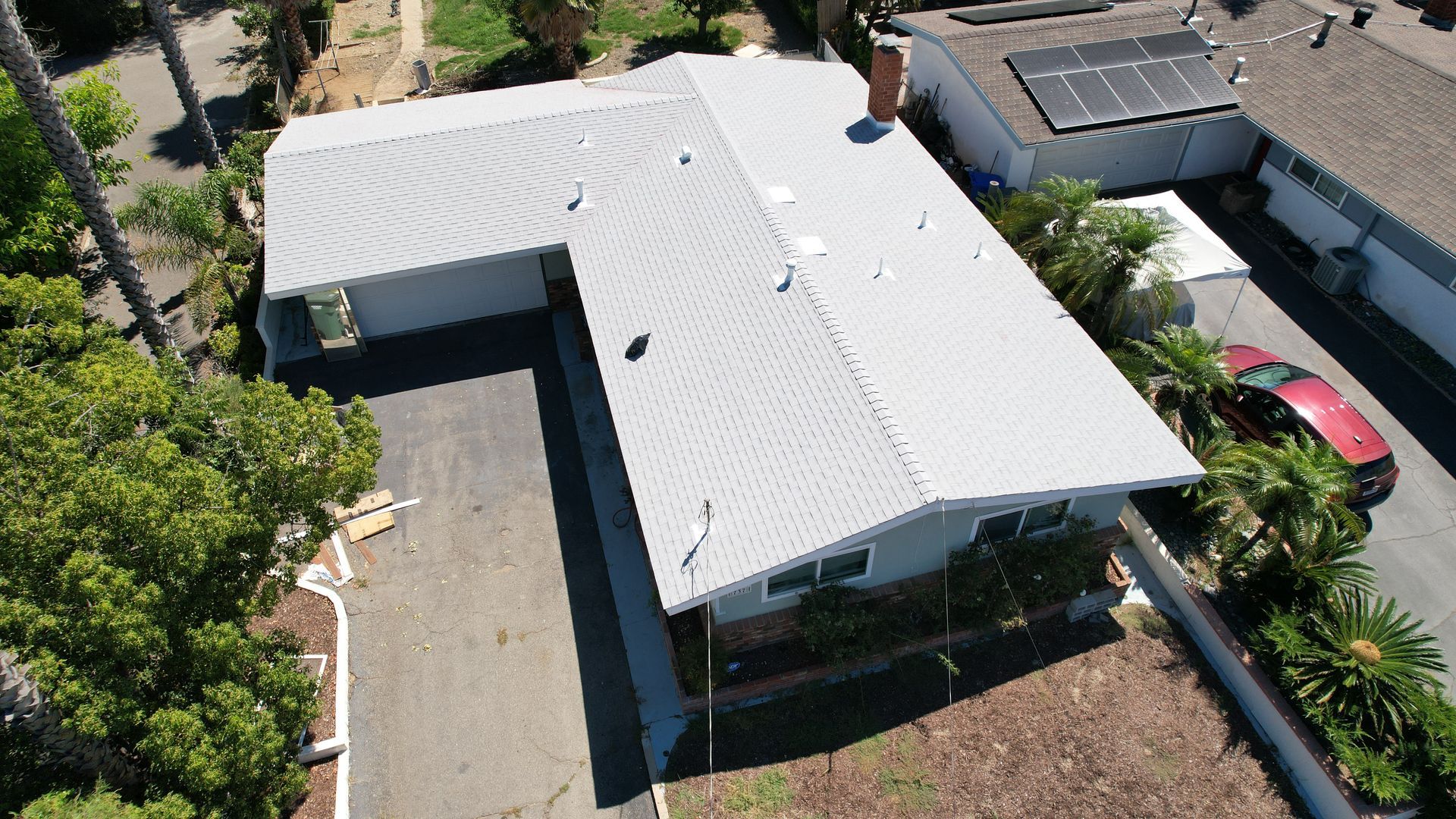 An aerial view of a house with solar panels on the roof