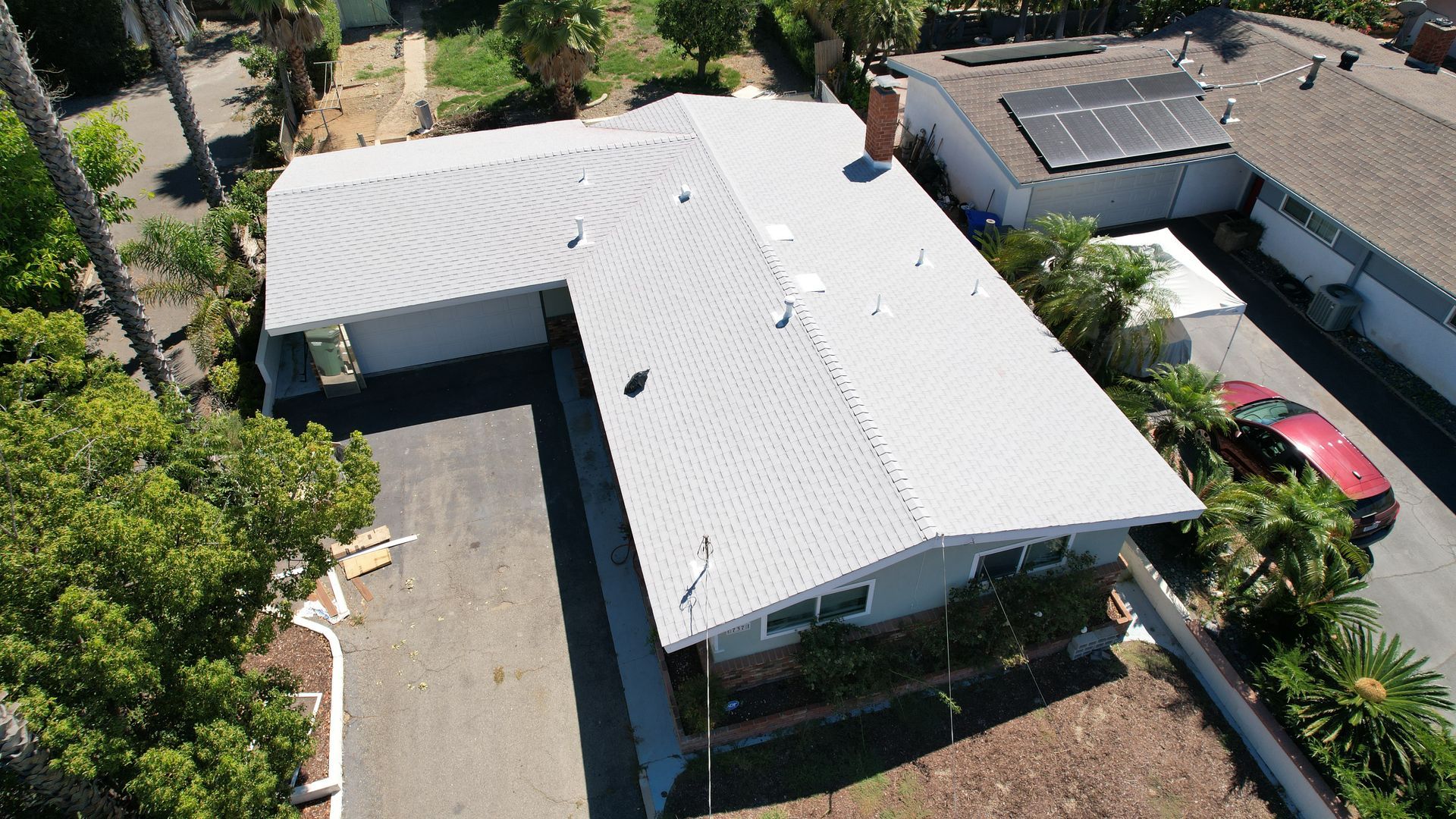 An aerial view of a house with a white roof