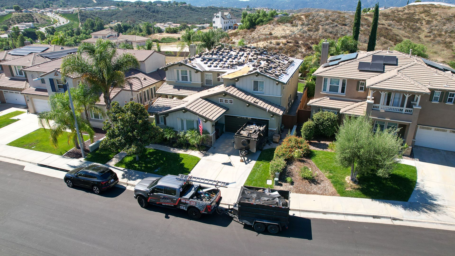 A group of cars are parked in front of a house