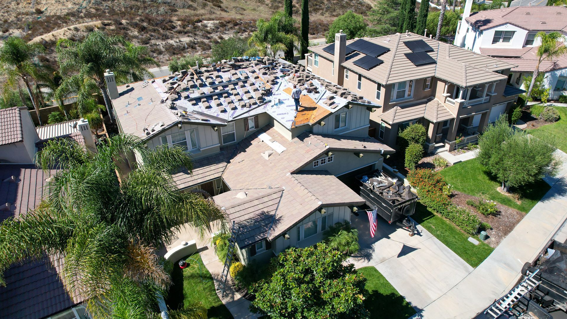 An aerial view of a house with solar panels on the roof